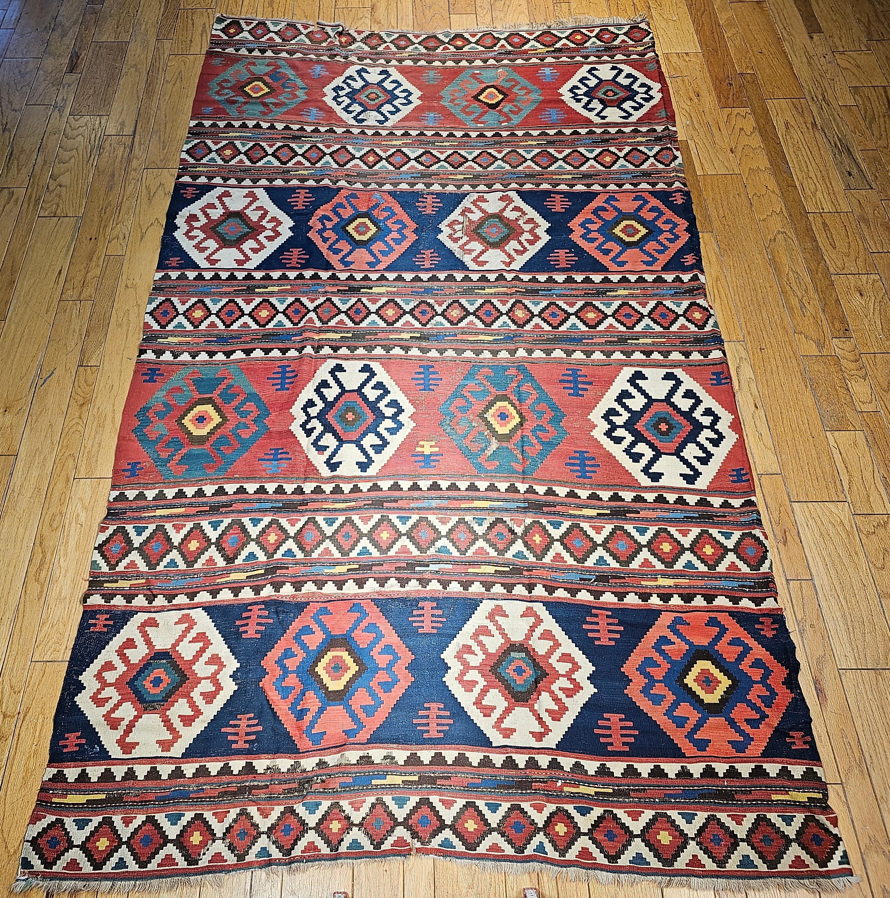 19th Century Caucasian Kazak room size kilim in blue, green, pink, ivory, navy, and yellow.   Since Kilims are tapestry type flatweaves (no pile), finding a room size one that is over 125 years in a good condition is extremely rare. This Caucasian