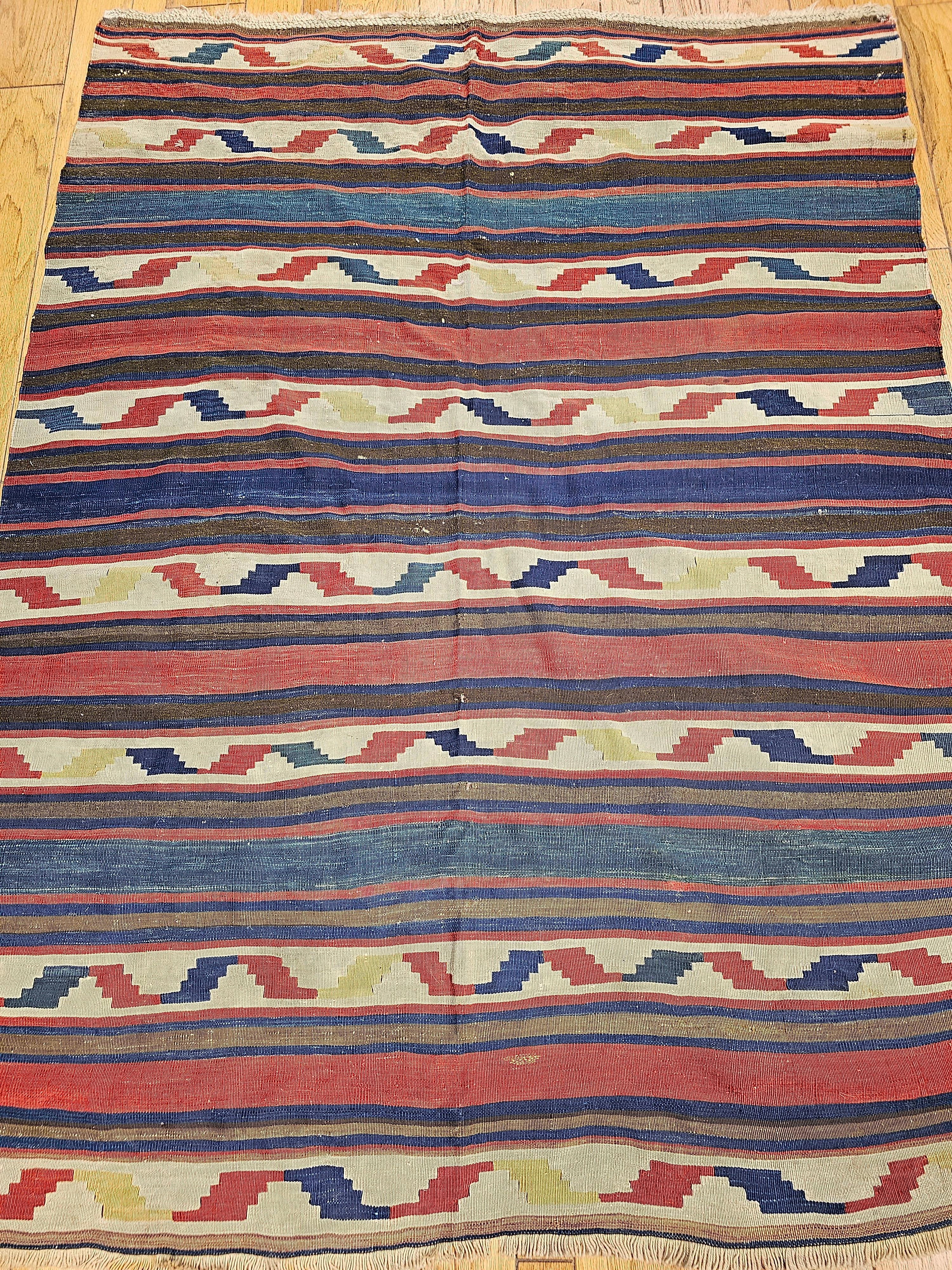  This beautiful Caucasian Kilim has the true essence of the village and tribal weaving. The Turkish Kilim has brilliant colors including abrash blue, yellow, brick red, brown, and ivory.   The design and colors in this kilim are very similar to