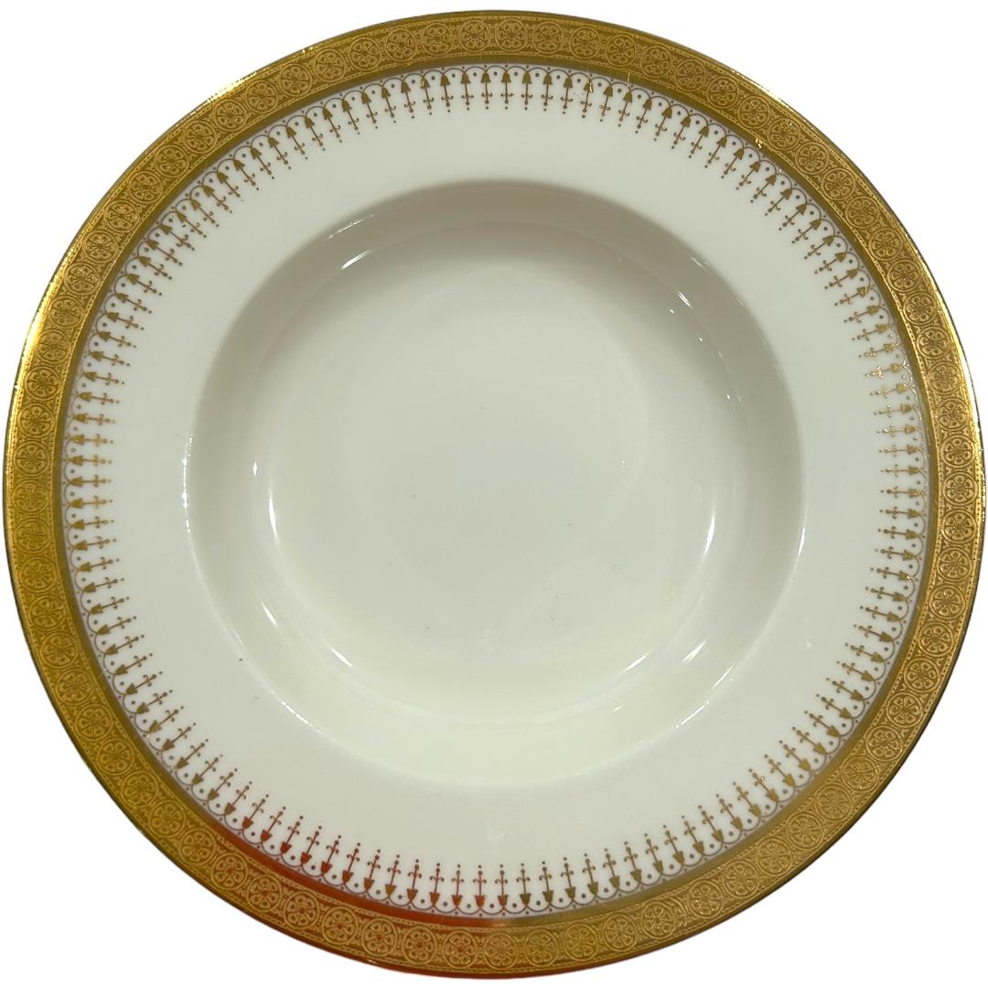 This vintage set of bowls by Cauldon for Tiffany & Co. boasts a classic white design with gold trim, perfect for collectors and those who appreciate elegant dinnerware.  Made in England, these bowls feature a translucent quality and are ideal for