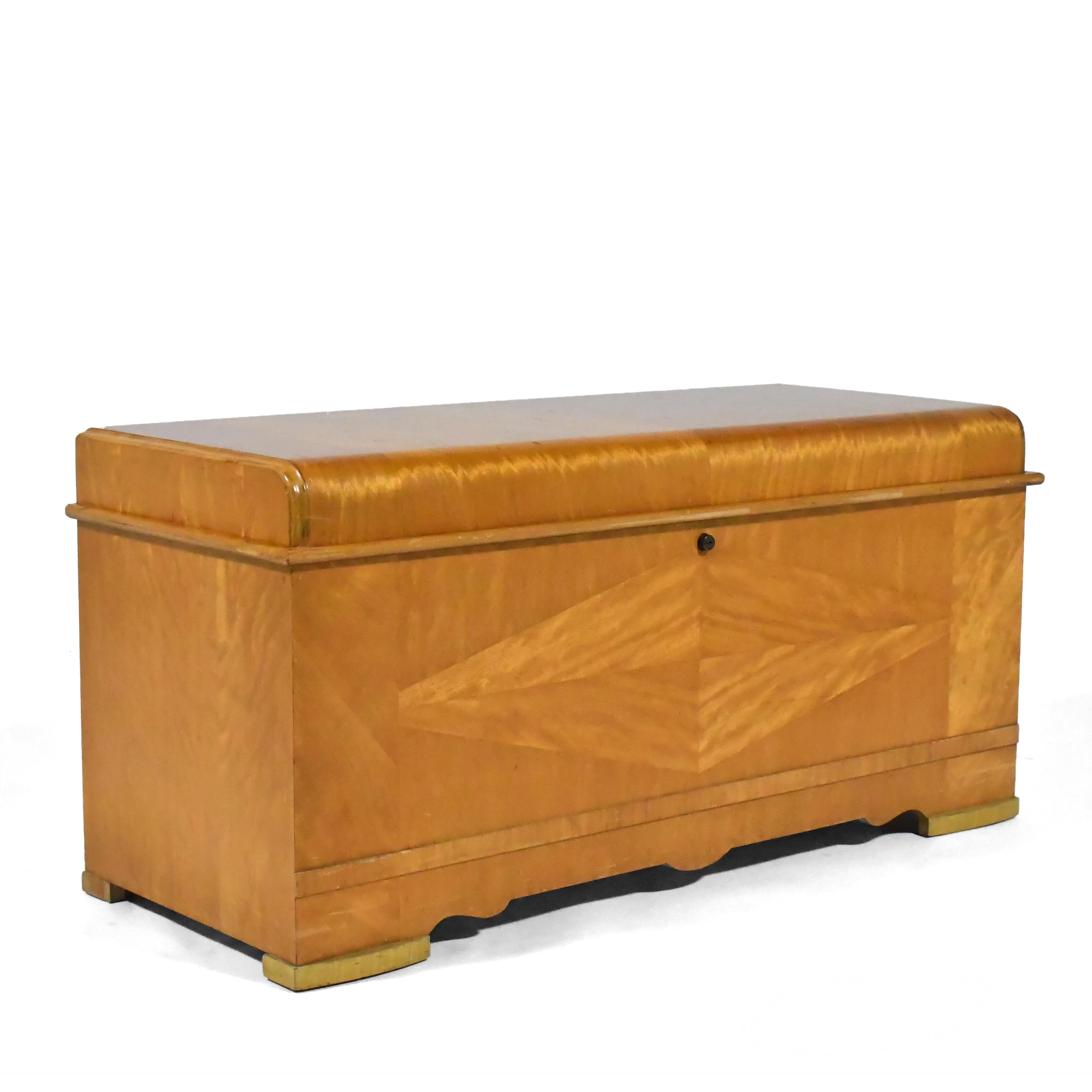 A beautiful place to store blankets or keepsakes, this striking Cavelier red cedar hope chest is expertly crafted and clad in a very active flame mahogany. A generous interior is enhanced with the shallow tray for small items. The waterfall edge and