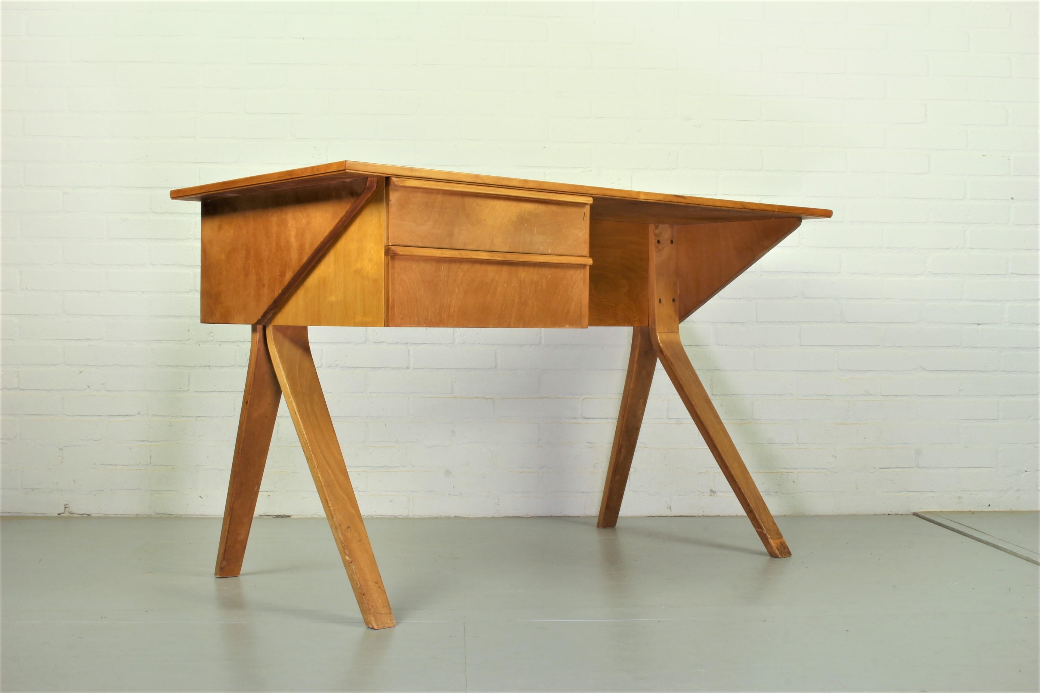 An early plywood model EB02 desk on splayed legs, designed by Cees Braakman for Pastoe, Netherlands, 1952. Braakman was the head designer at UMS Pastoe, Utrecht, one of the largest and most respected Dutch modernist furniture manufacturers of the