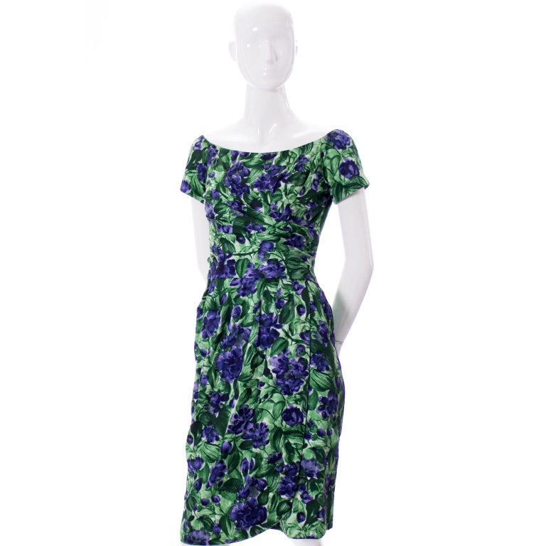 This vintage Ceil Chapman dress is so lovely! This incredible dress has beautiful ruching, which was a signature of most of Chapman's 1950's dresses, and the green and purple floral printed cotton is crisp and bright. The dress has a metal 18 inch