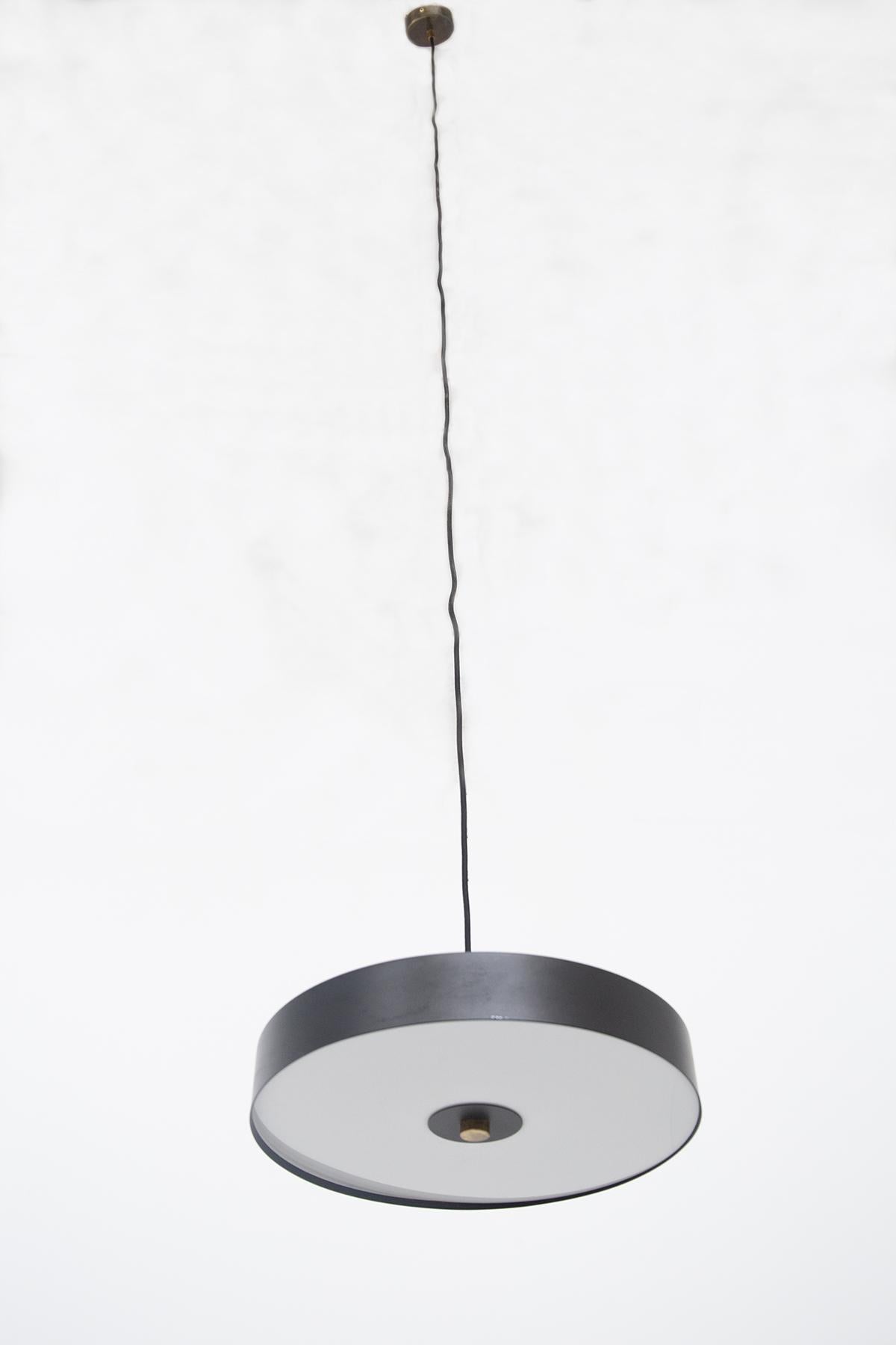 Gorgeous vintage ceiling lamp made in the 2000s.
The ceiling lamp is made of black aluminum and has a round shape, very beautiful and elegant.
The lamp has a brass insert that connects it to the wire, as well as the round plate that fixes it to