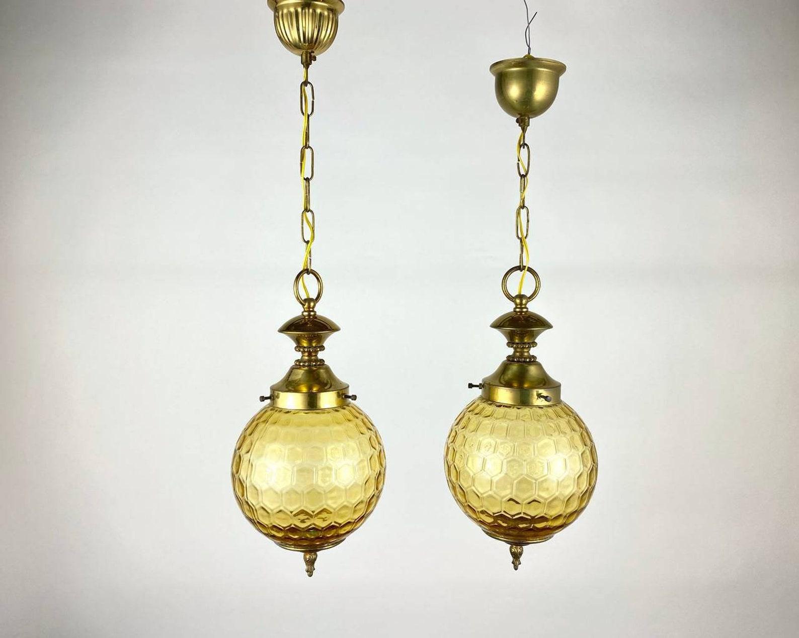 Vintage textured glass in the form of honeycomb and gilded brass ceiling chandeliers or lanterns. 

 Manufactured in Belgium, circa 1980s.

 Beautifully detailed, vintage paired hanging lamps, lanterns. The textured glass plafond is set in a