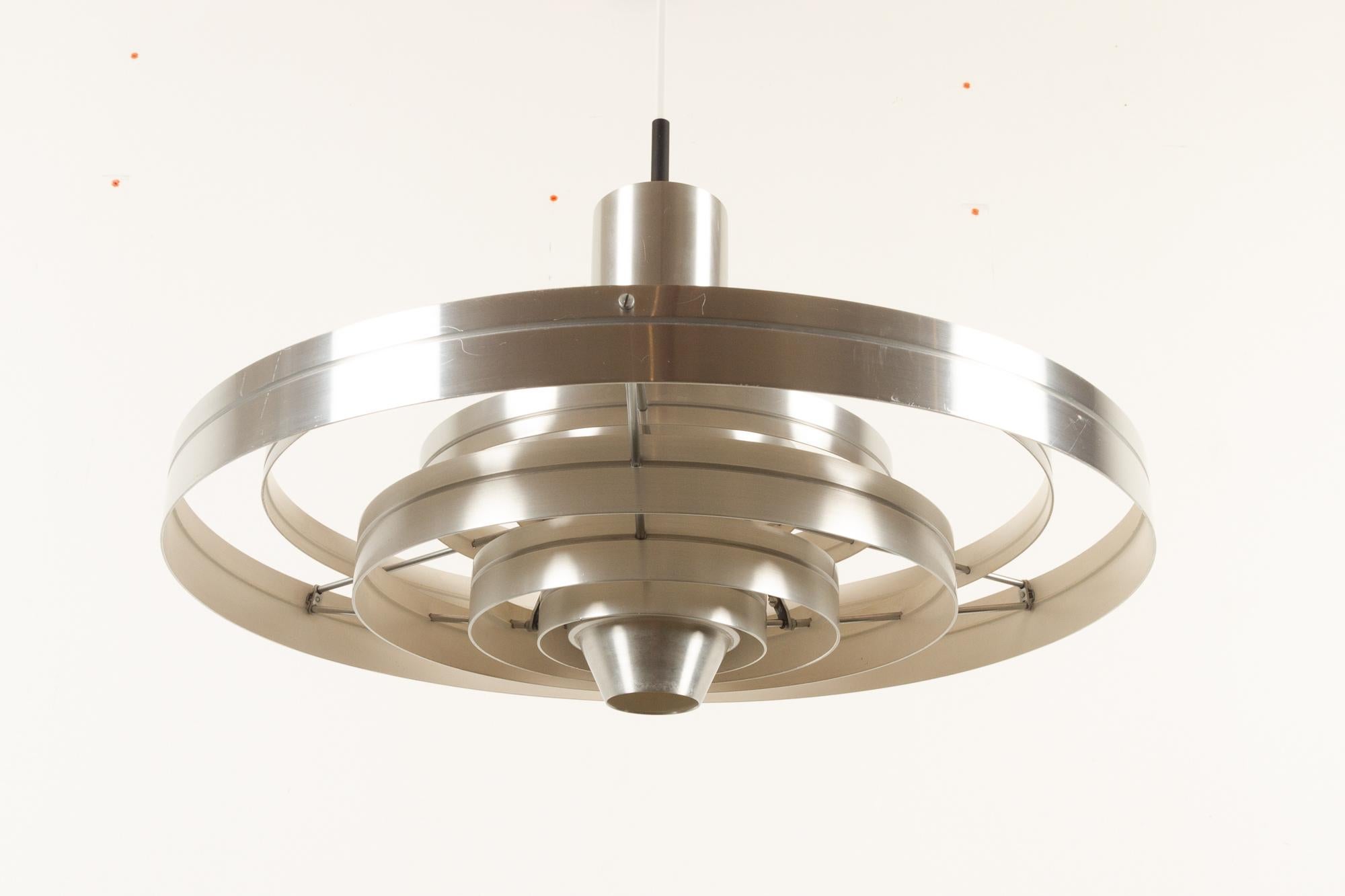 Vintage ceiling pendant Fibonacci by Sophus Frandsen for Fog & Mørup, 1960s
Danish lamp in aluminium designed by Sophus Frandsen. The lamp consist of six floating rings that diffuses the light evenly in all directions. The lamp can be suspended