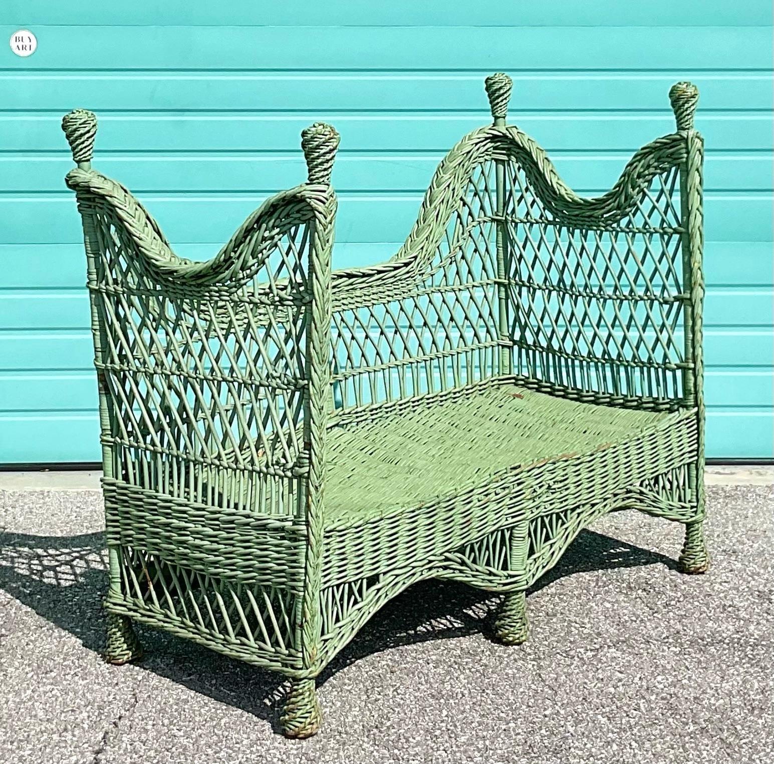 Exquisite early 1900s Victorian settee painted in a celadon color. Braid trim detailing and fully woven ball posts at all four corners make this piece one of the most intricate we have seen from the era.