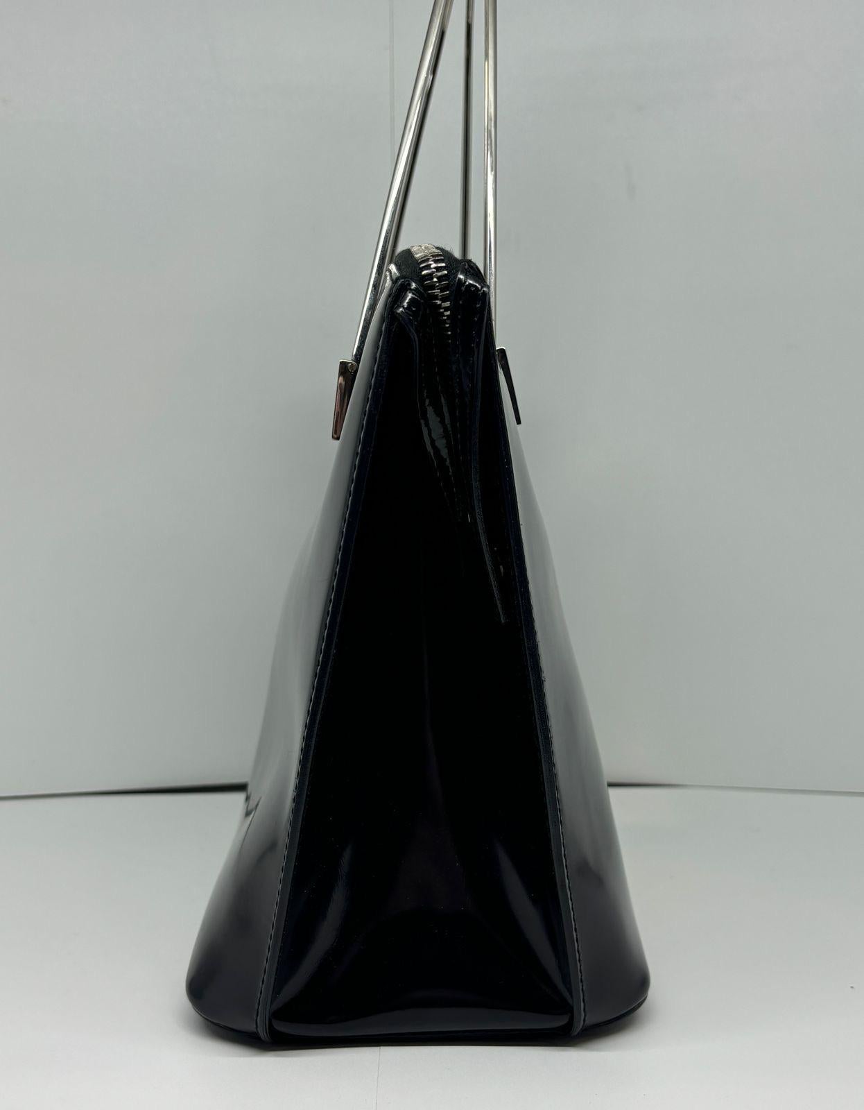 Vintage celine black patent zip tote. Beautiful metal handles detail with logo engraving. Overall in very good vintage condition, with minor scuff on the bottom area of one side. The patent is not sticky, more like a glossy finish to the leather.