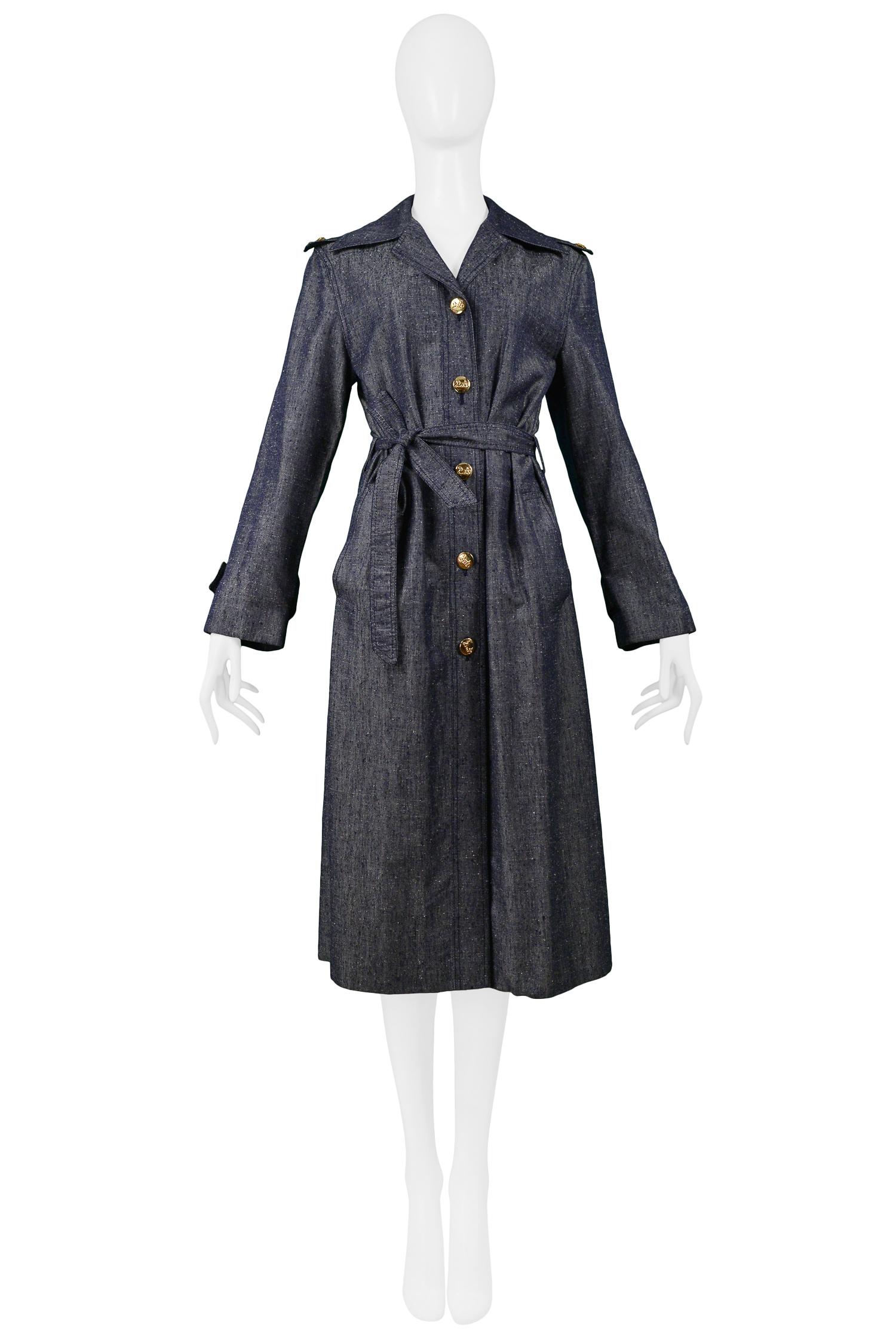 Vintage Celine Sport denim belted trench coat with gold tone buttons featuring the classic horse and carriage logo, epaulet detailing at shoulders and belted wrists. Circa 1970's.

Excellent Condition.

Size 40.