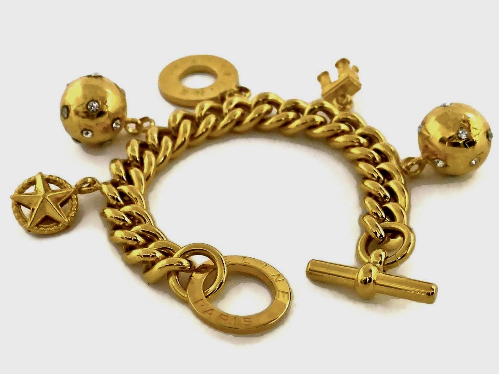 Vintage CELINE Iconic Charm Chain Bracelet

Measurements:
Height: 2 inches (5 cm)
Wearable Length: 7.5 inches (19 cms)

Features:
- 100% Authentic CELINE PARIS.
- 5 iconic Celine logo emblem charms.
- Gold tone.
- Toggle closure.
- Signed CELINE
