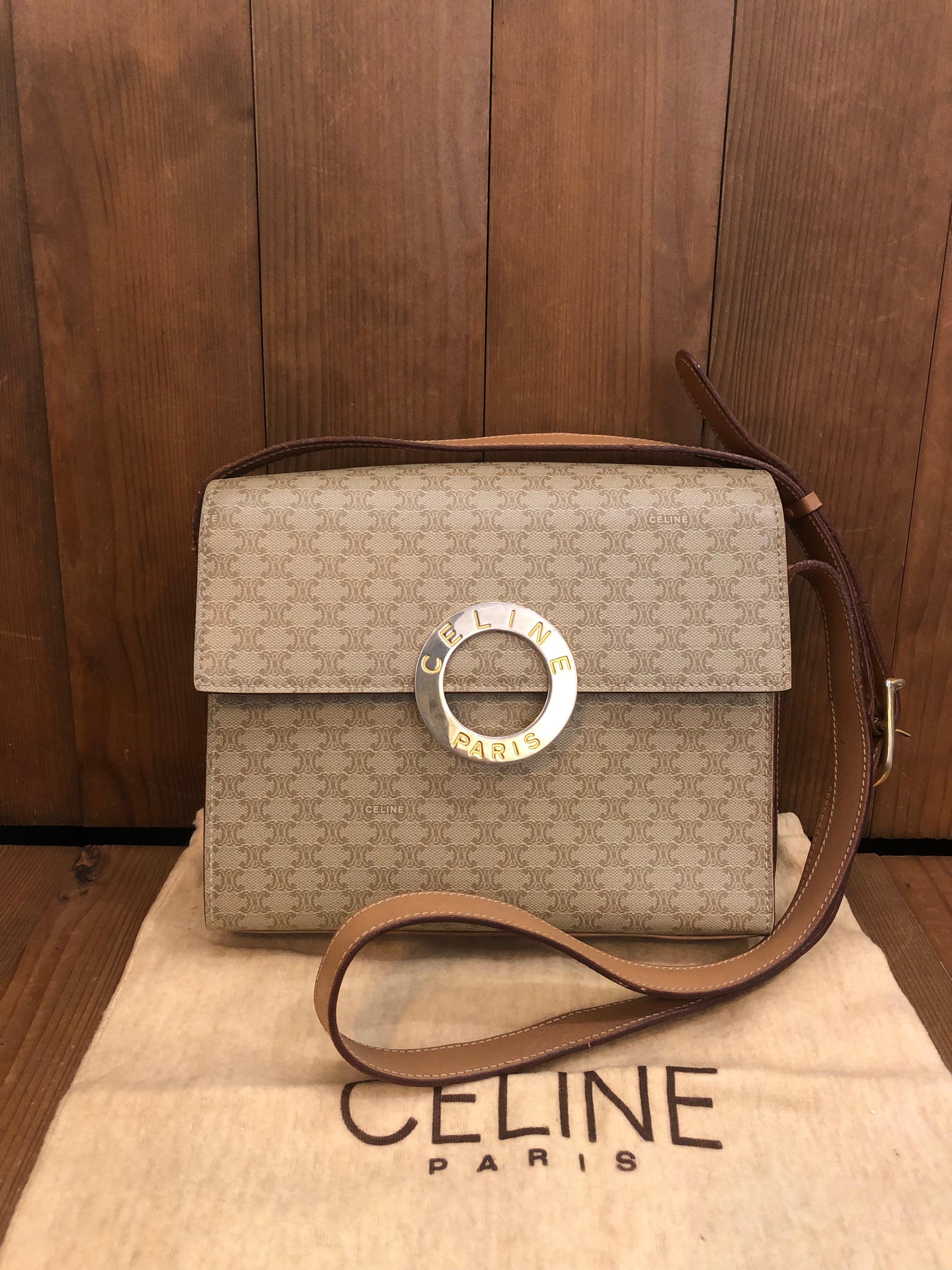 This vintage CELINE box shoulder bag is crafted of Celine’s signature Macadam Canvas in beige featuring a sturdy cowhide leather shoulder strap. Front flap CELINE RIng magnetic snap closure opens to a beige leather interior featuring patch pockets