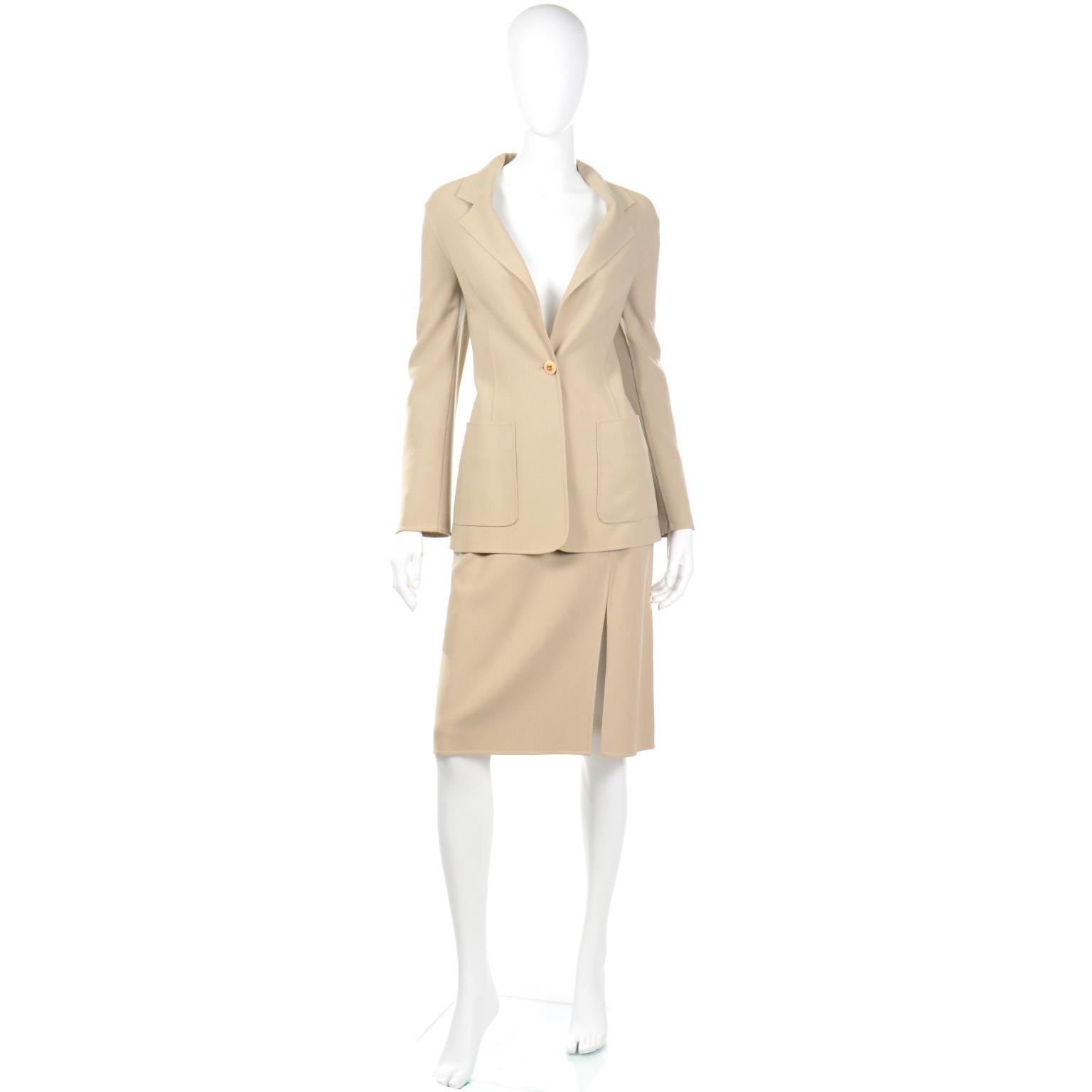 This is a lovely Celine sand colored minimalist monochromatic two piece skirt suit with a single buttoned blazer style jacket. This is such a sophisticated ensemble that can be broken up to be worn as separates. The jacket has front flap pockets and