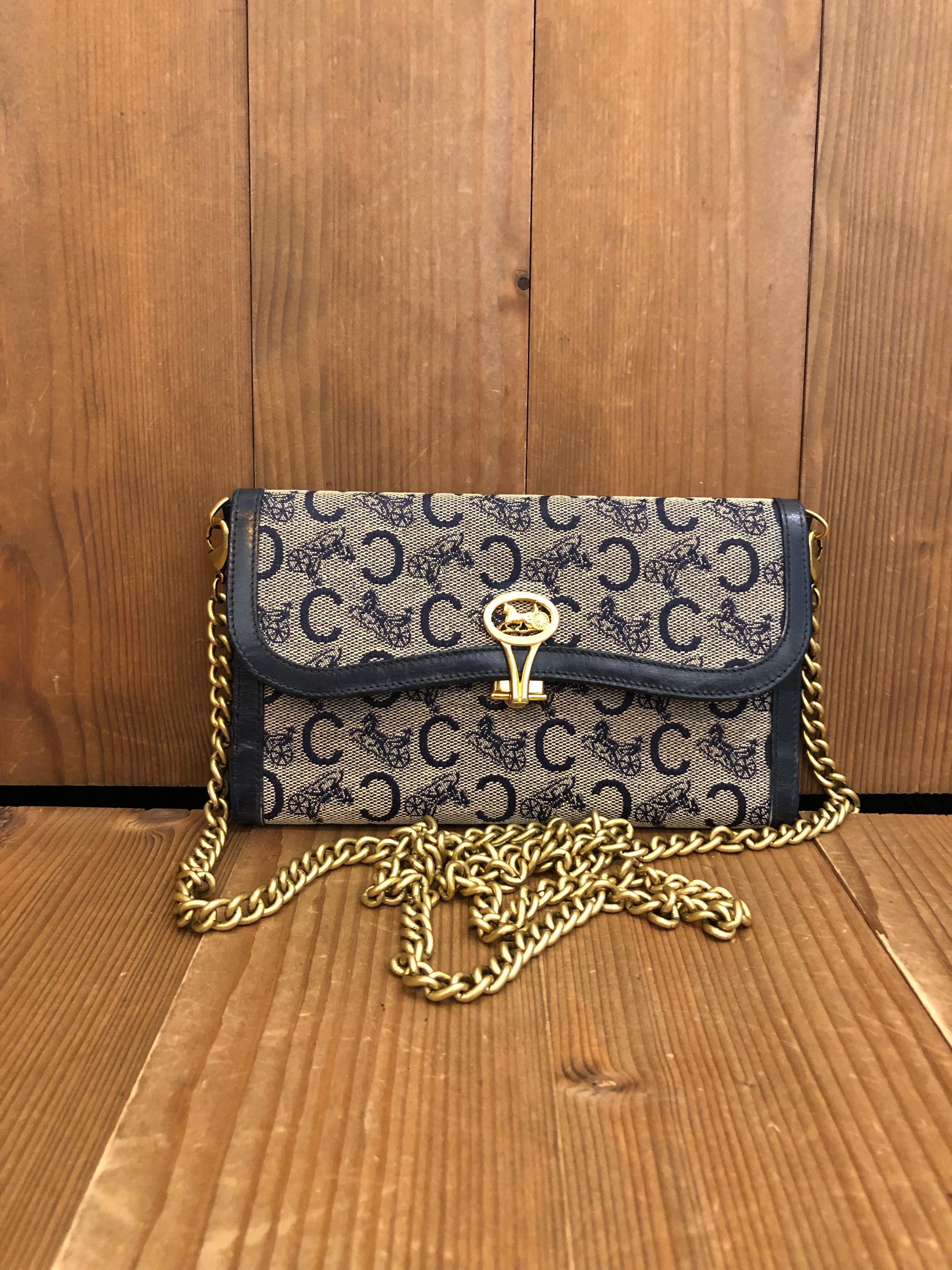 This vintage CELINE tri-fold long wallet is crafted of Celine monogram jacquard and leather in navy. Celine gold toned buckle open to an all leather interior in navy featuring 4 general pockets and 1 coin pocket. With the gold toned chain and