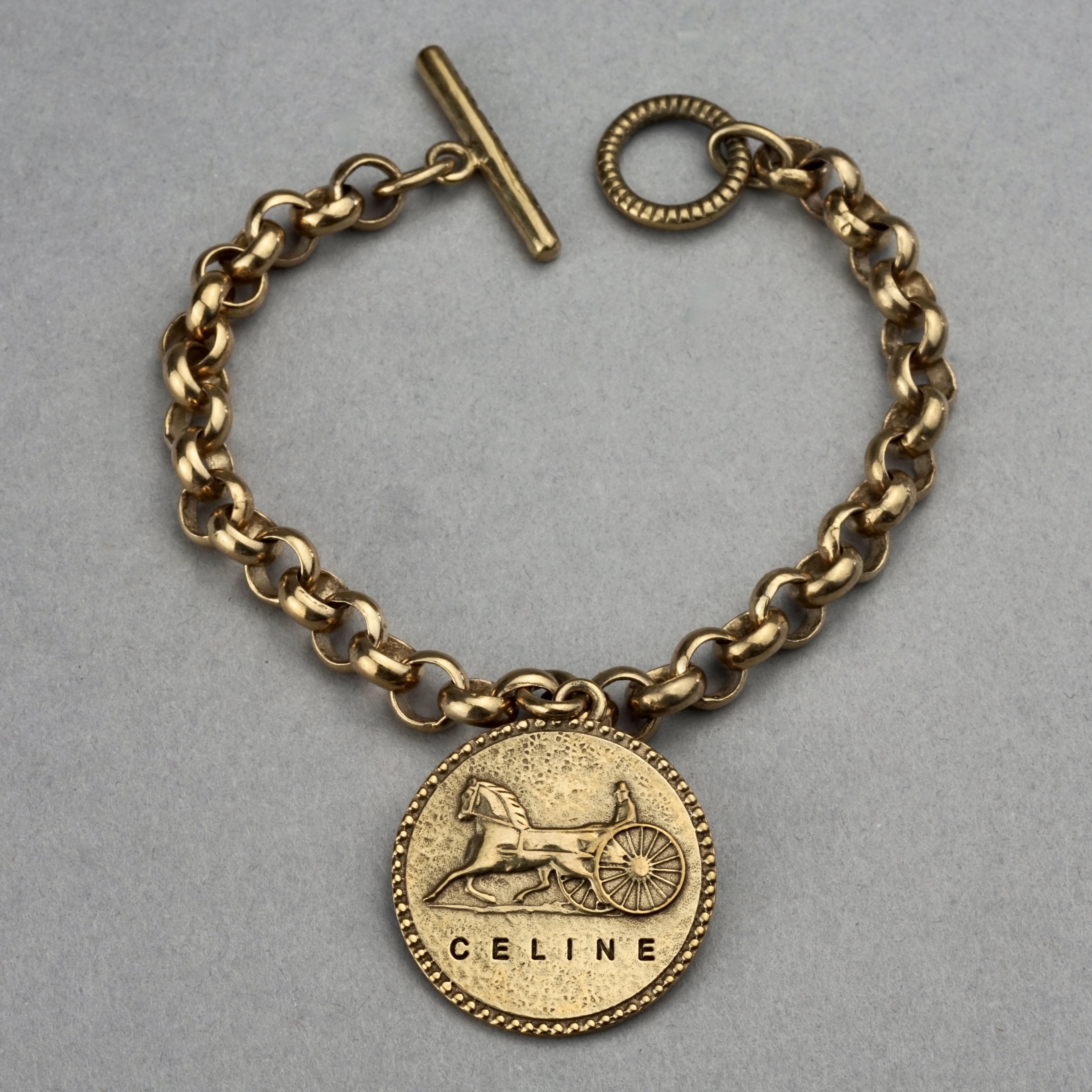 Vintage CELINE PARIS Horse Carriage Medallion Chain Bracelet

Measurements:
Height: 1.22 inches (1.10 cm)
Wearable Length: 7.48 inches (19 cms)

Features:
- 100% Authentic CELINE PARIS.
- Chain bracelet with iconic horse carriage medallion charm.
-