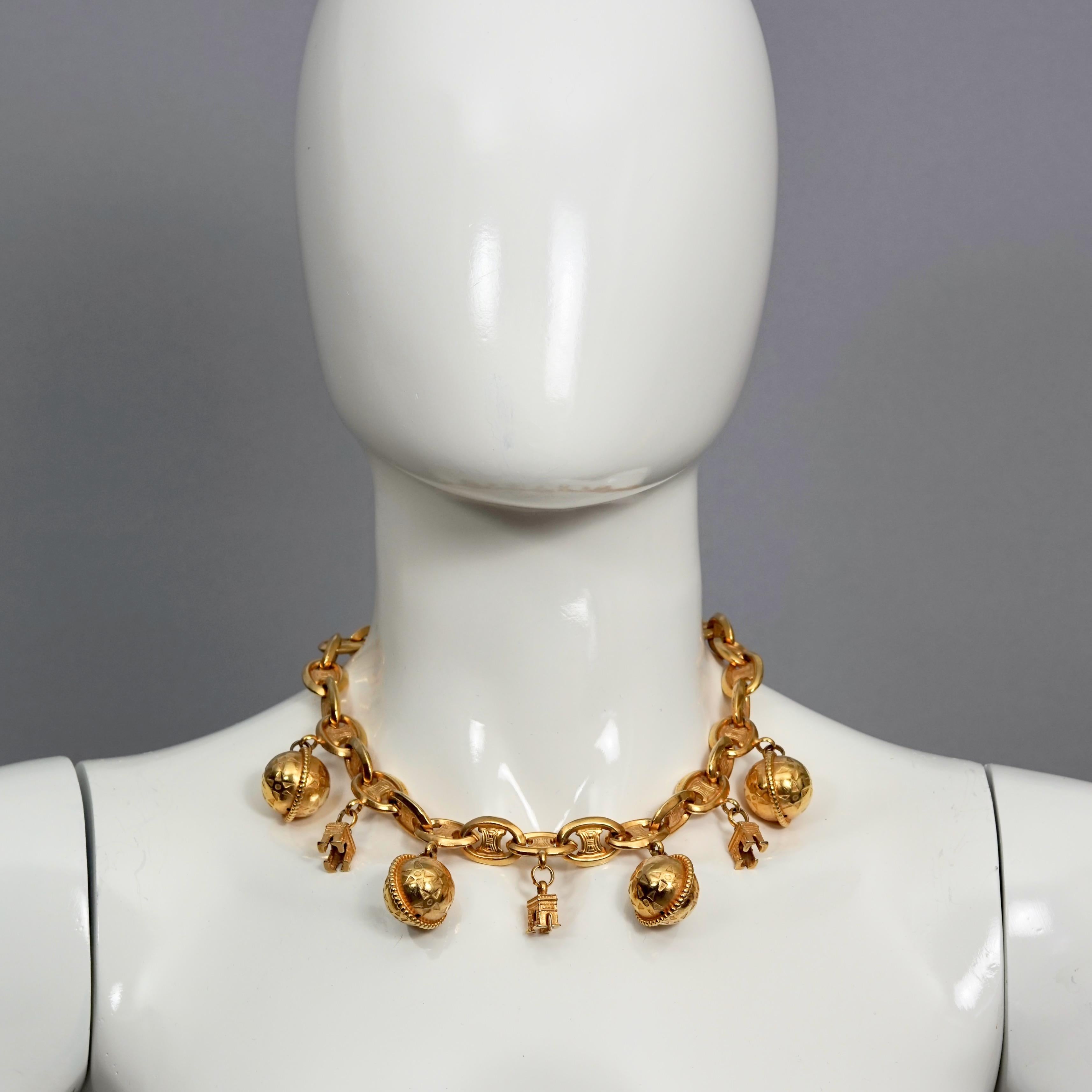 Vintage CELINE PARIS Iconic Arc de Triomphe Planet Charms Choker Necklace

Measurements:
Height: 1.77 inches (4.5 cm)
Wearable Length: 17.32 inches (44 cm)

Features:
- 100% Authentic CELINE Paris.
- Chunky choker necklace in gold tone.
- Iconic