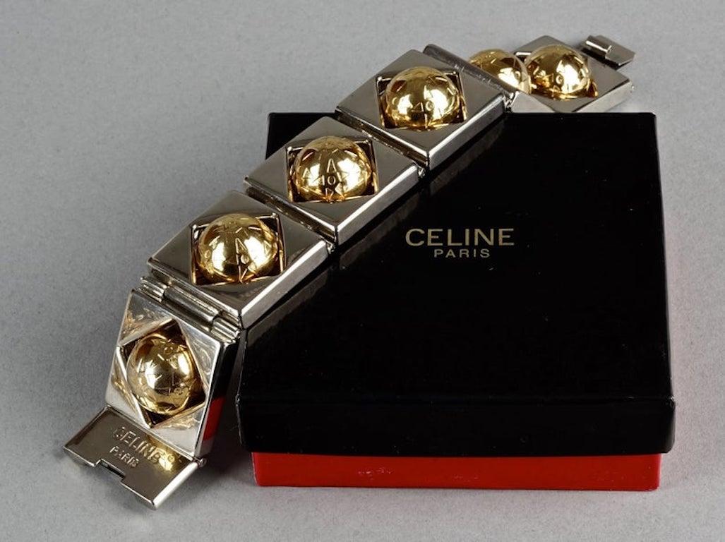 Vintage CELINE PARIS Planisphere Geometric Link Bracelet

Measurements:
Height: 1.18 inches (3 cm)
Wearable Length: 8.46 inches (21.5 cm)

Features:
- 100% Authentic CELINE Paris.
- Chunky bracelet in gold and silver tone.
- Compose of 6 square