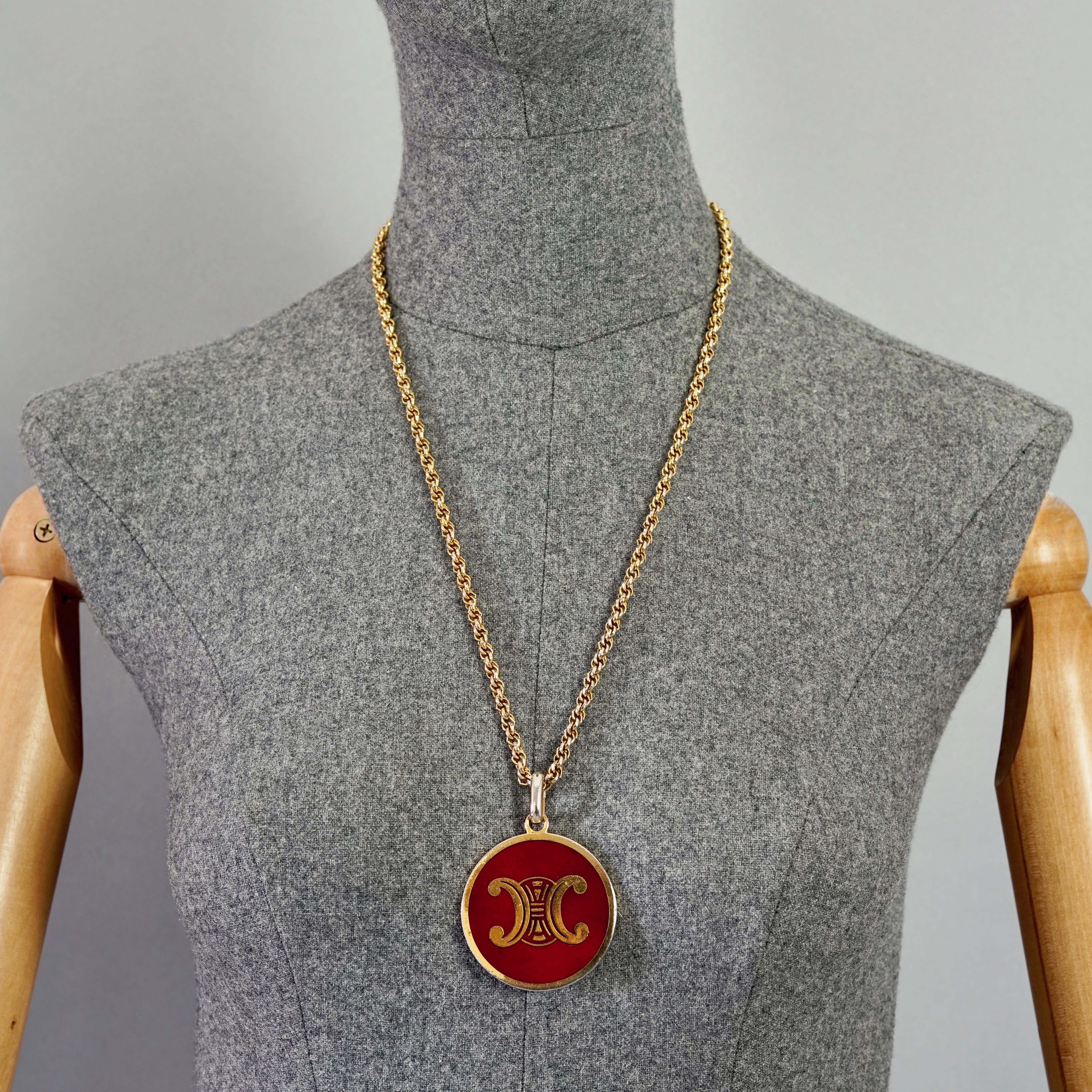 Vintage CELINE PARIS Triomphe Logo Red Enamel Medallion Pendant

Measurements:
Pendant Diameter: 1.92 inches  (4.9 cm)
Overall Length: 24.40 inches (62 cm)

Features:
- 100% Authentic CELINE PARIS pendant.
- Iconic Celine's TRIOMPHE logo in on red