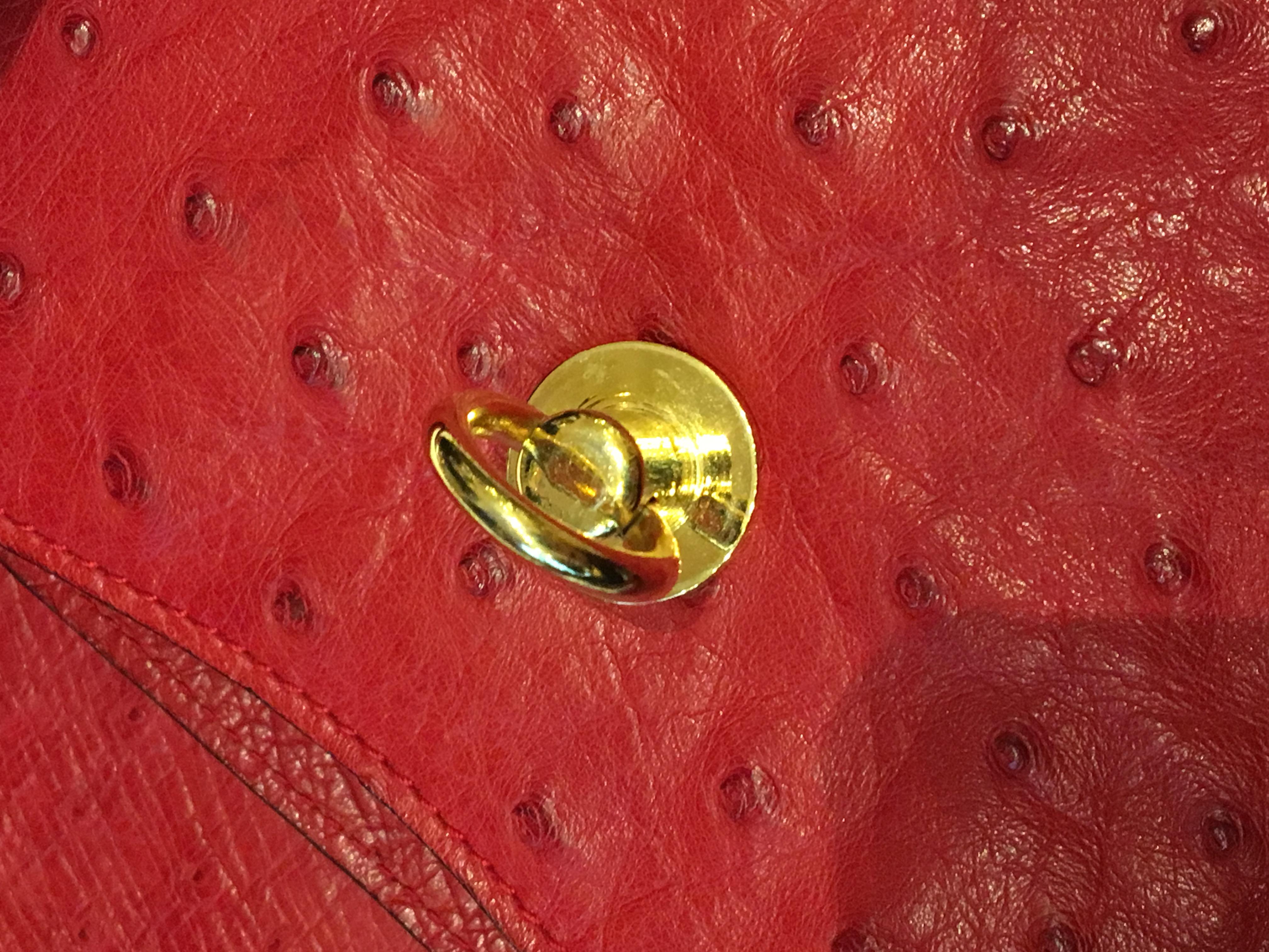 Women's or Men's Vintage Celine Red Ostrich bag with golden hardware.