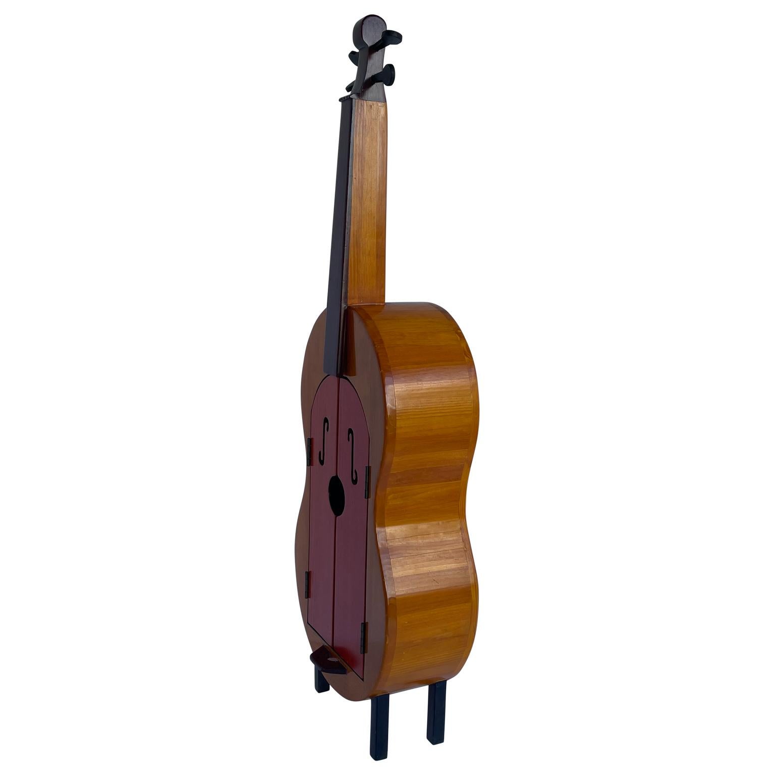Vintage full size Cello cabinet with 6 shelves.
What a fun piece this is! The tall handsome Cello has so many functions; a dry bar, a bookshelf, a collectible display case, the list is endless. Red lacquered doors with decorative tempo design add