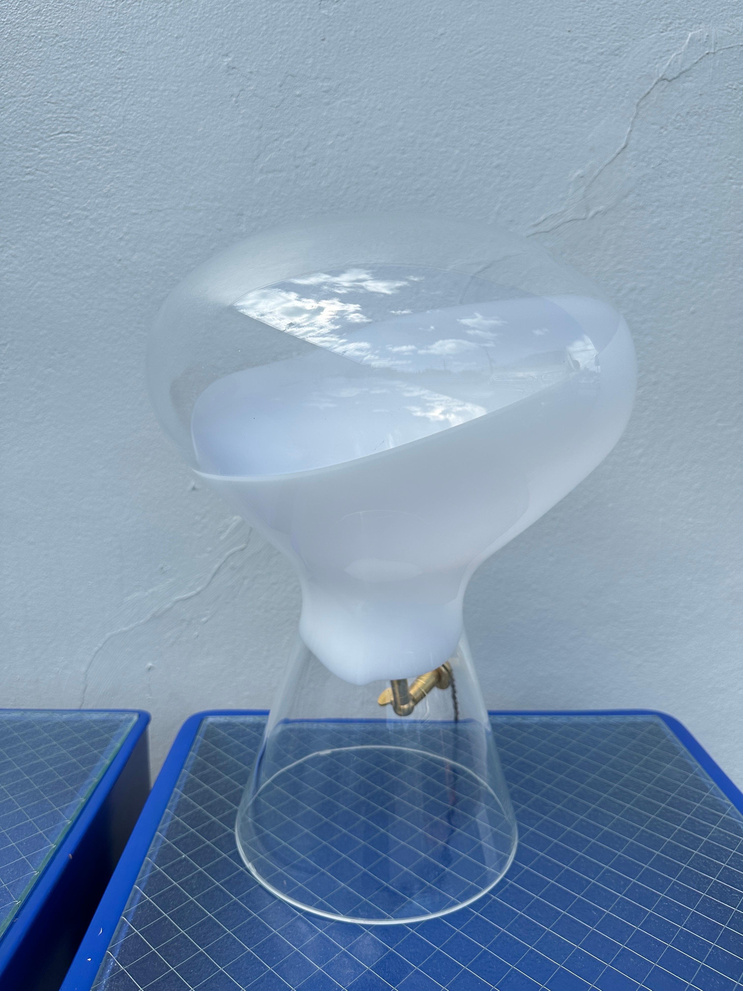This Cenedese Murano glass lamp is so unique with a bulbous head and flared base. The electrical components are intentionally visible to add an industrial feeling, with new silk wiring. The glass piece itself has a half white and half clear top, so