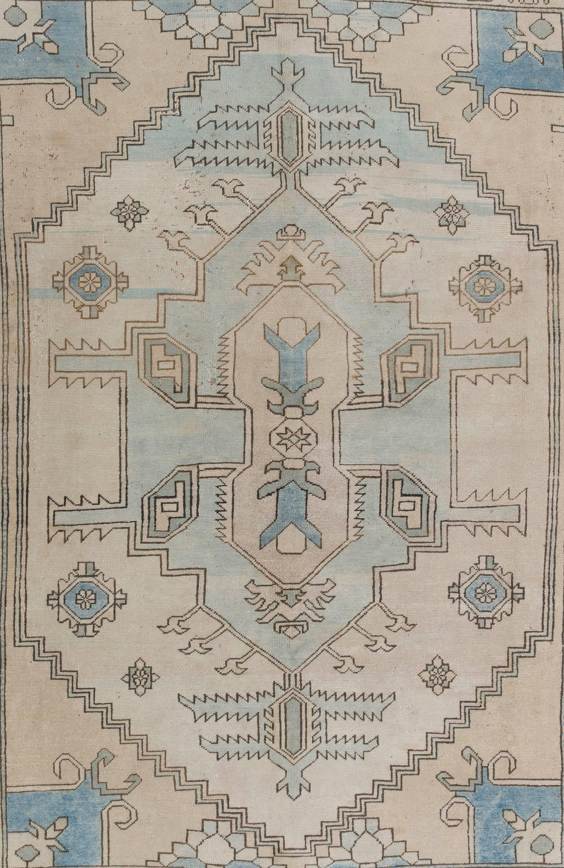 A vintage handmade Central Anatolian rug with a bold design and soft, pastel colors of cream, beige and baby blue. Finely hand-knotted with even medium wool pile on wool foundation. Excellent condition. Sturdy and as clean as a brand new rug (deep