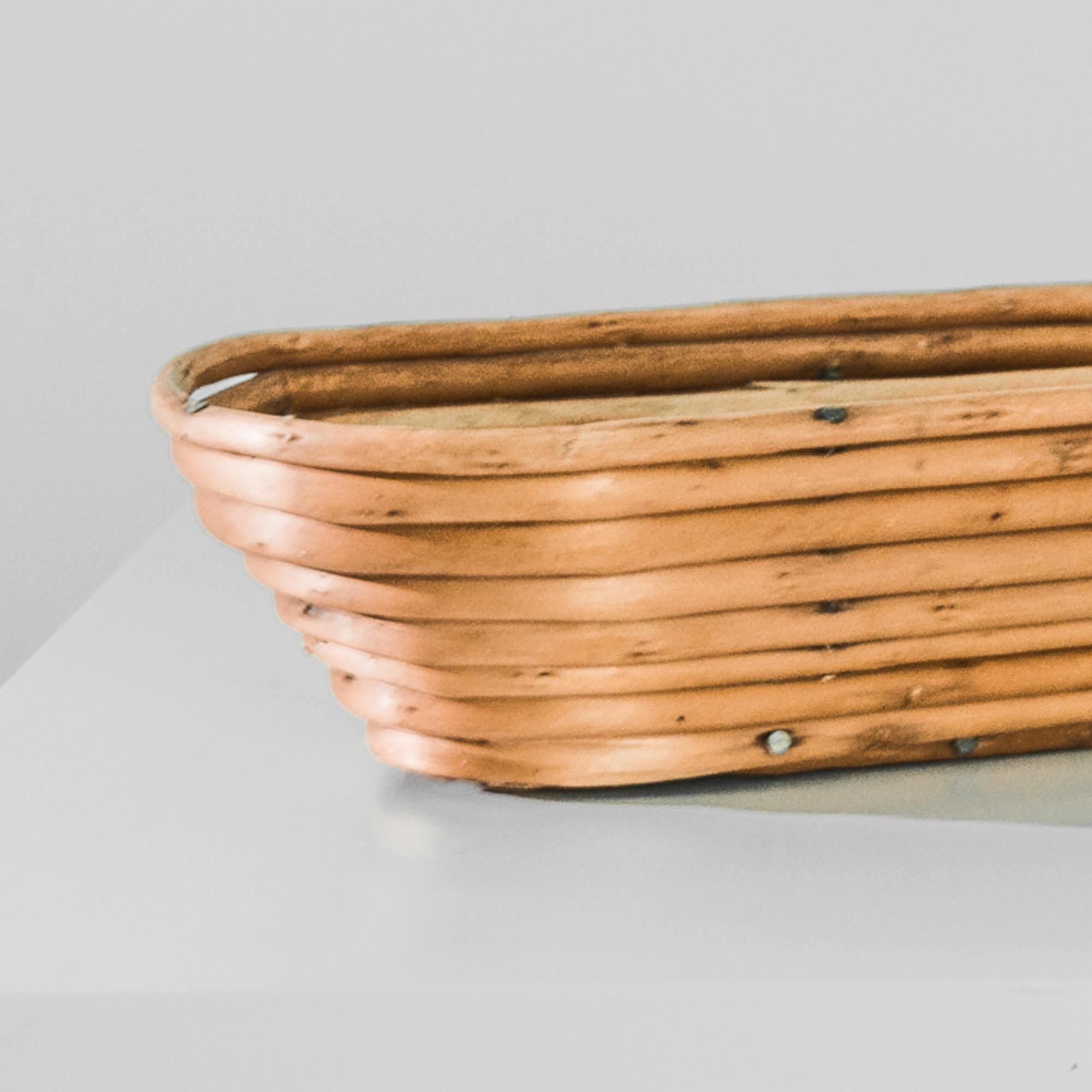 Retired from an old world bakery, this rattan basket was sourced in Czech Republic. Dated to approximately 1900, this essential tool from a bustling early 20th century bakery, displays the charms of its age. Three inches tall and one foot wide, this