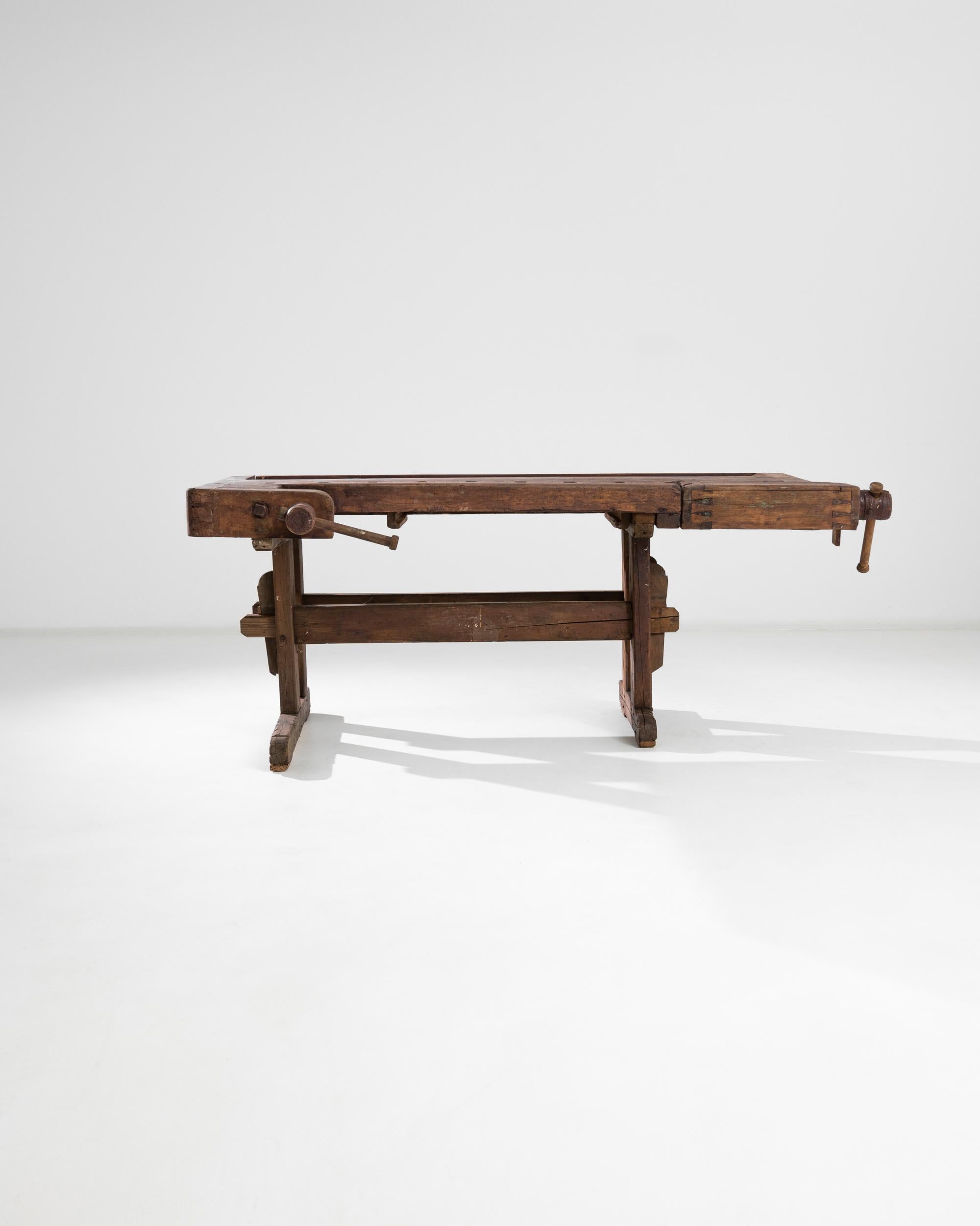 A vintage Central European wooden work table. A gentle giant, this pleasantly asymmetrical work table offers function and time-tested style. Even with dovetailed joints and mortise and tenon legs this table understates its own gravitas, while