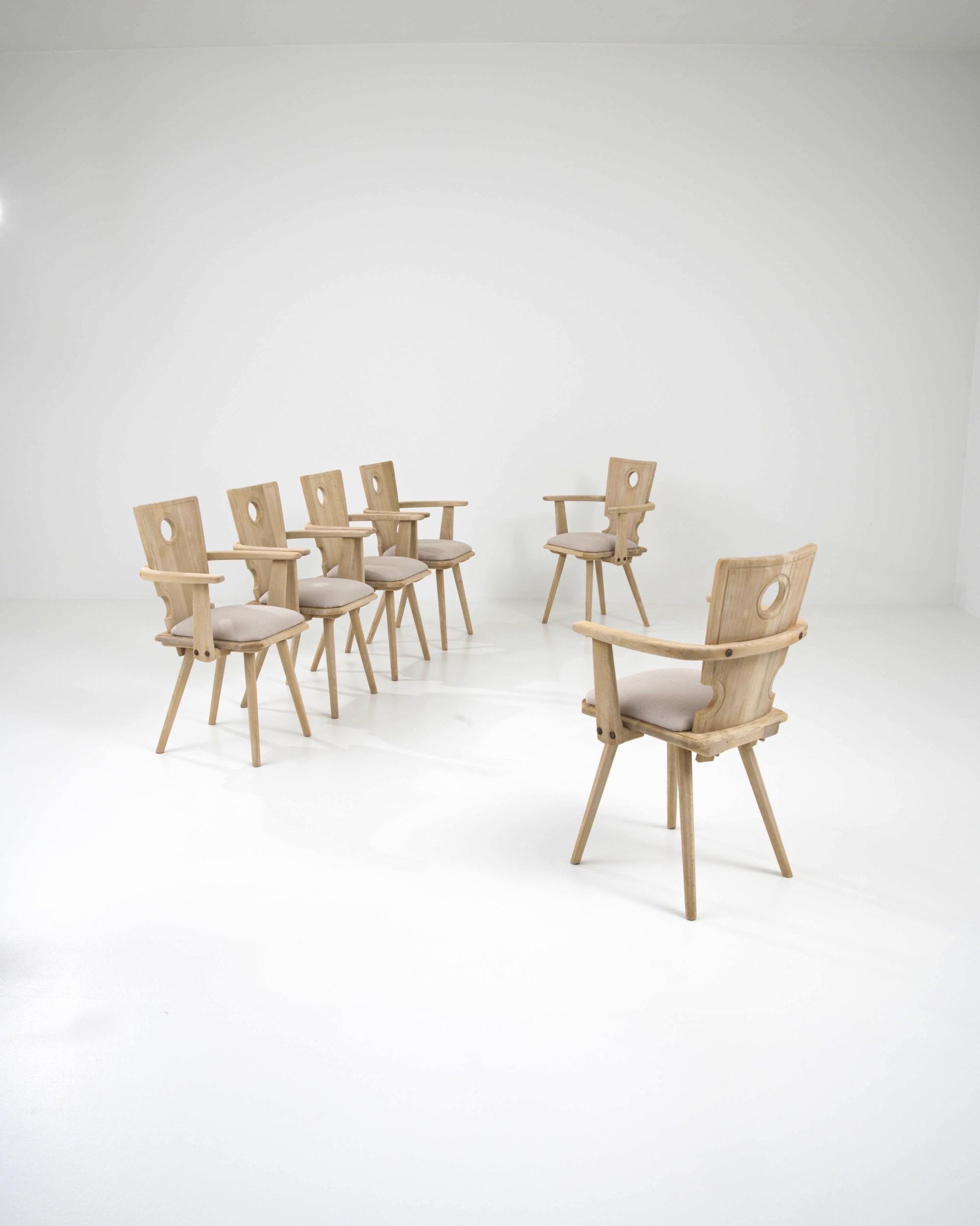 A pale hue and refined country silhouette give this vintage set of six wooden dining chairs a homey, serene character. Made in Central Europe in the 20th century, the form is inspired by traditional farmhouse chairs — with a touch of the