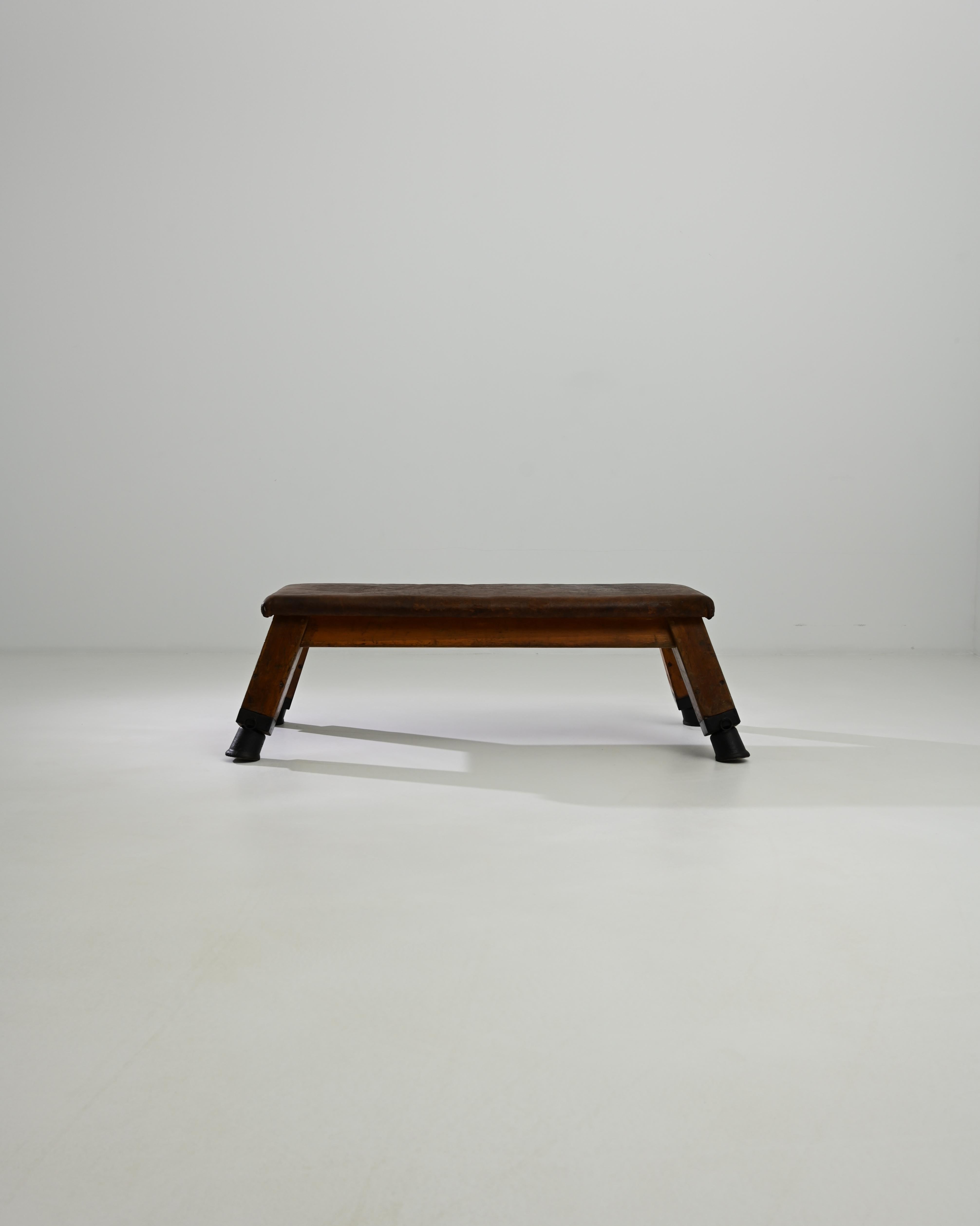 This leather pommel horse was made in Central Europe, circa 1950. A unique bench with a sense of history; handcrafted quality emits a sense of the robust – utility and a restful sense of ease. Originally used by gymnasts for swinging and balancing