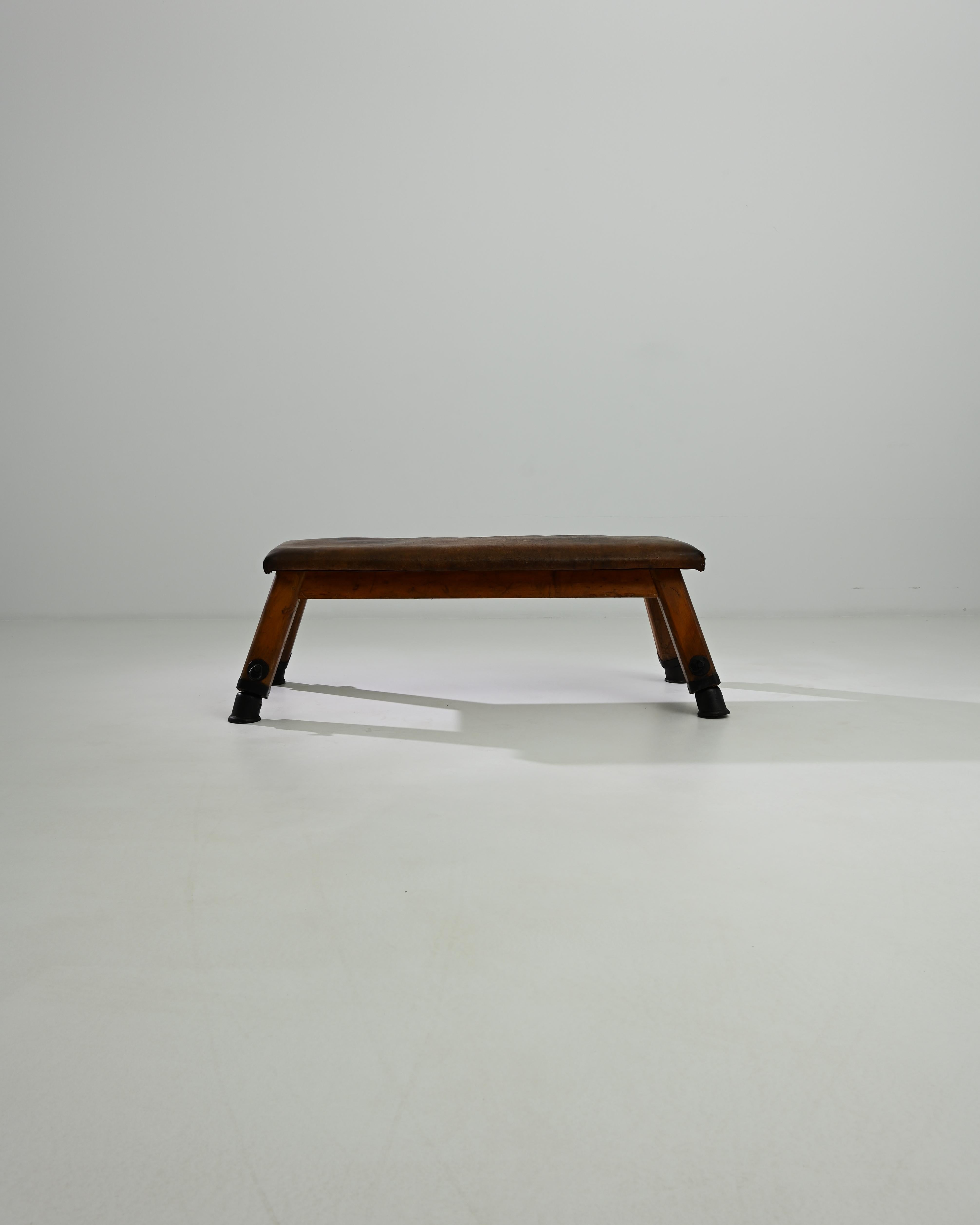 This leather pommel horse was made in Central Europe, circa 1950. A unique bench with a sense of history; handcrafted quality emits a sense of the robust – utility and a restful sense of ease. Originally used by gymnasts for swinging and balancing