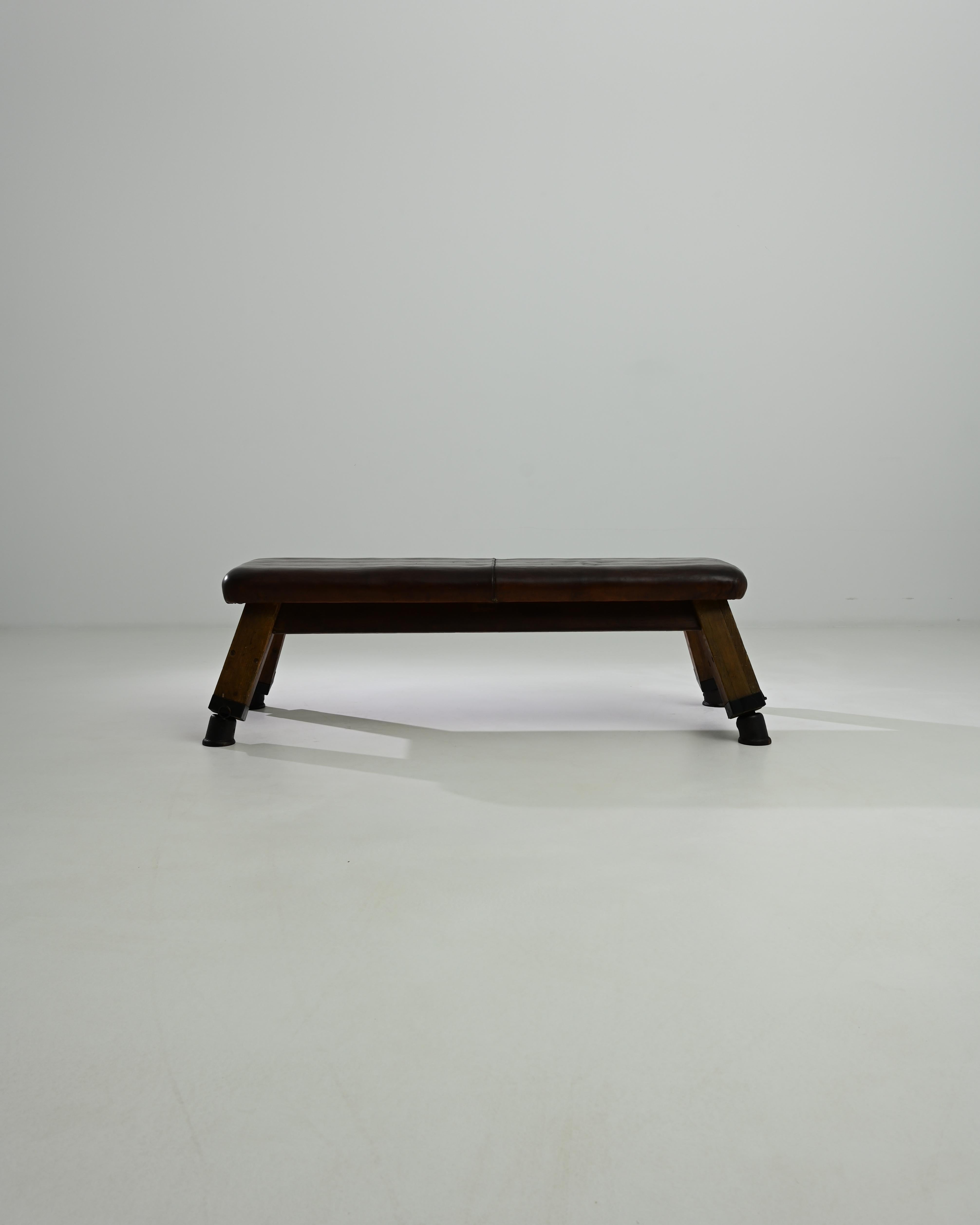 This leather pommel horse was made in Central Europe, circa 1950. A unique bench with a sense of history; hand-crafted quality emits a sense of the robust – utility and a restful sense of ease. Originally used by gymnasts for swinging and balancing