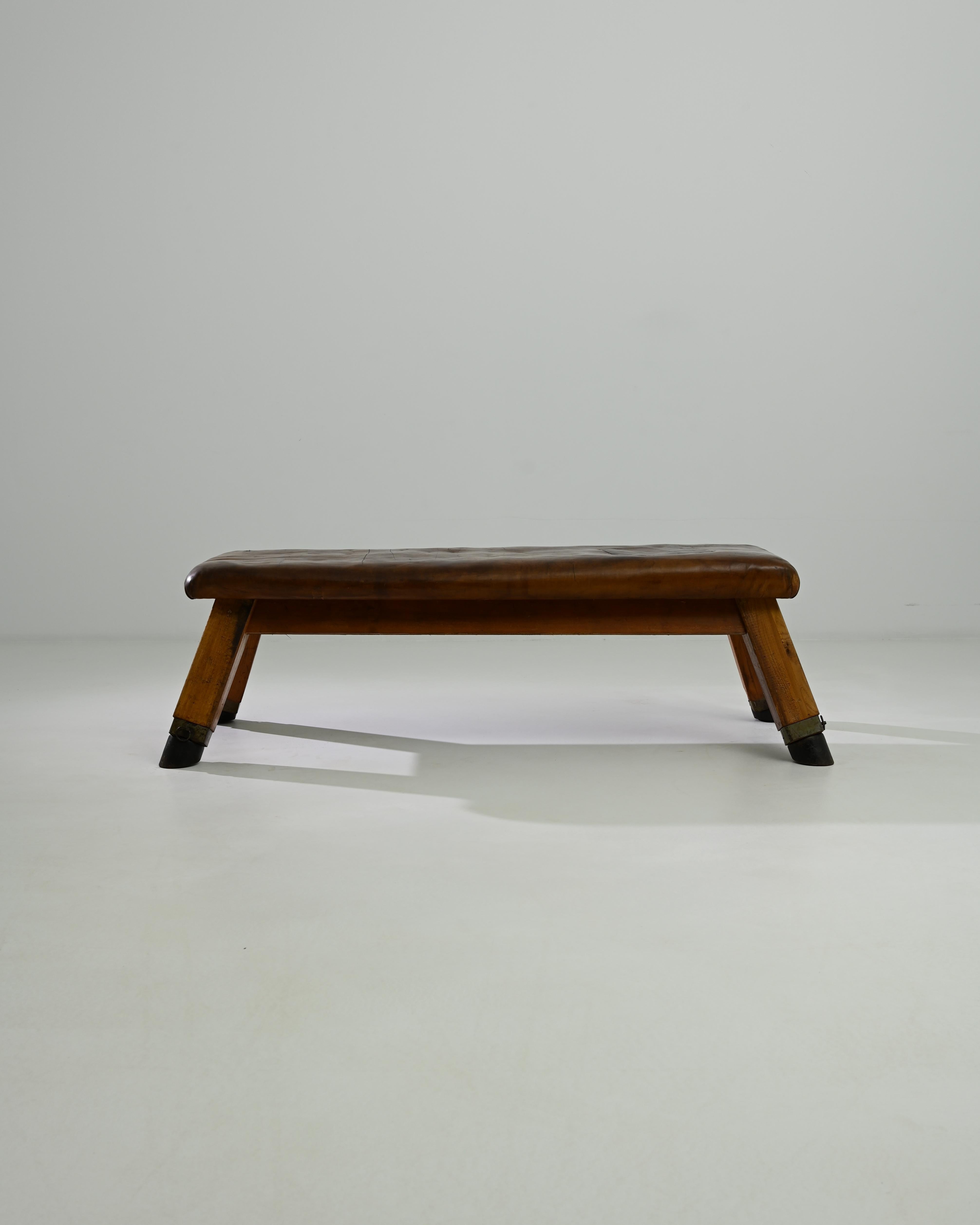 This leather pommel horse was made in Central Europe, circa 1950. A unique bench with a sense of history; handcrafted quality emits a sense of the robust – utility and a restful sense of ease. Originally used by gymnasts for swinging and balancing