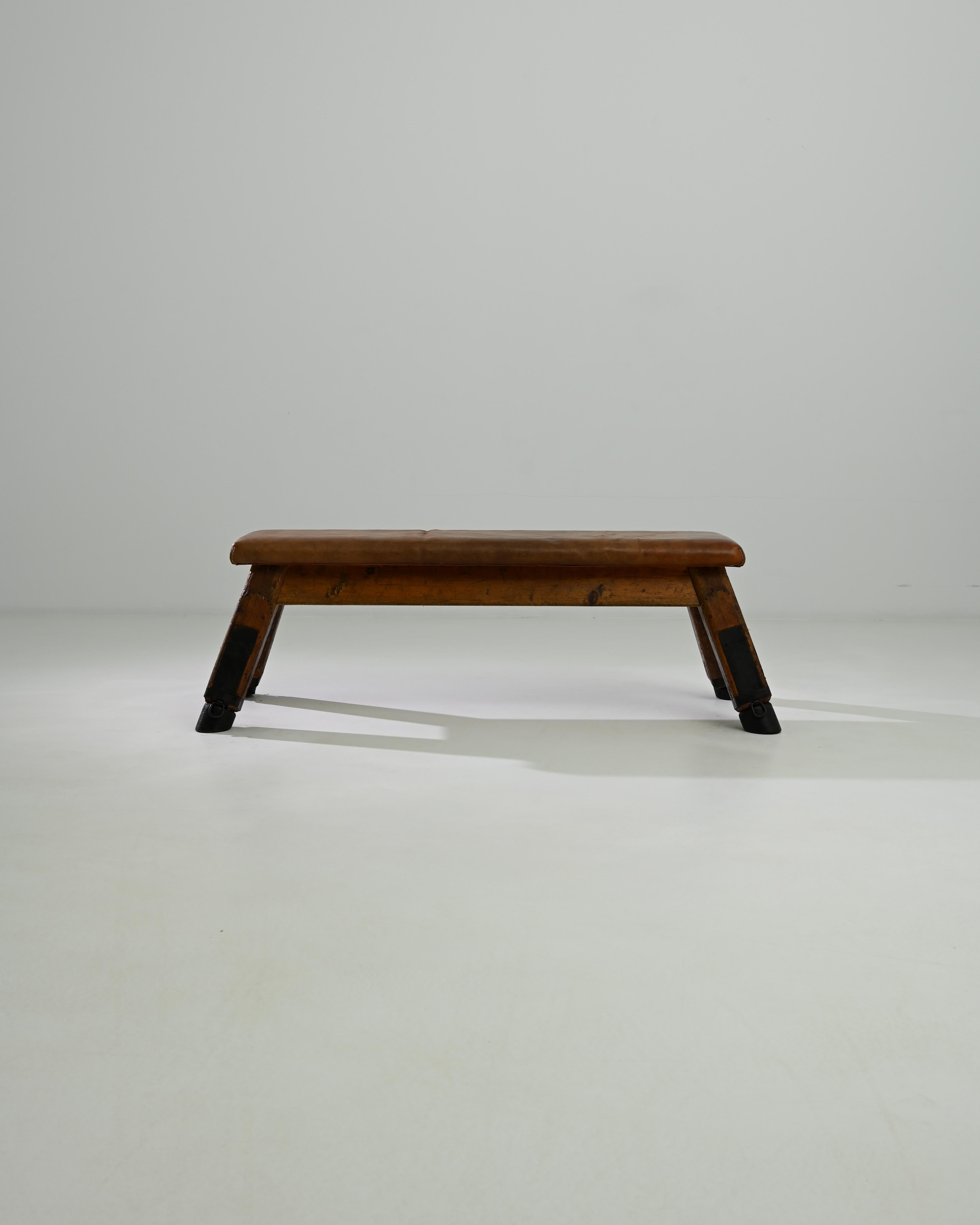 This leather pommel horse was made in Central Europe, circa 1950. A unique bench with a sense of history; handcrafted quality emits a sense of the robust – utility and a restful sense of ease. Originally used by gymnasts for swinging and balancing