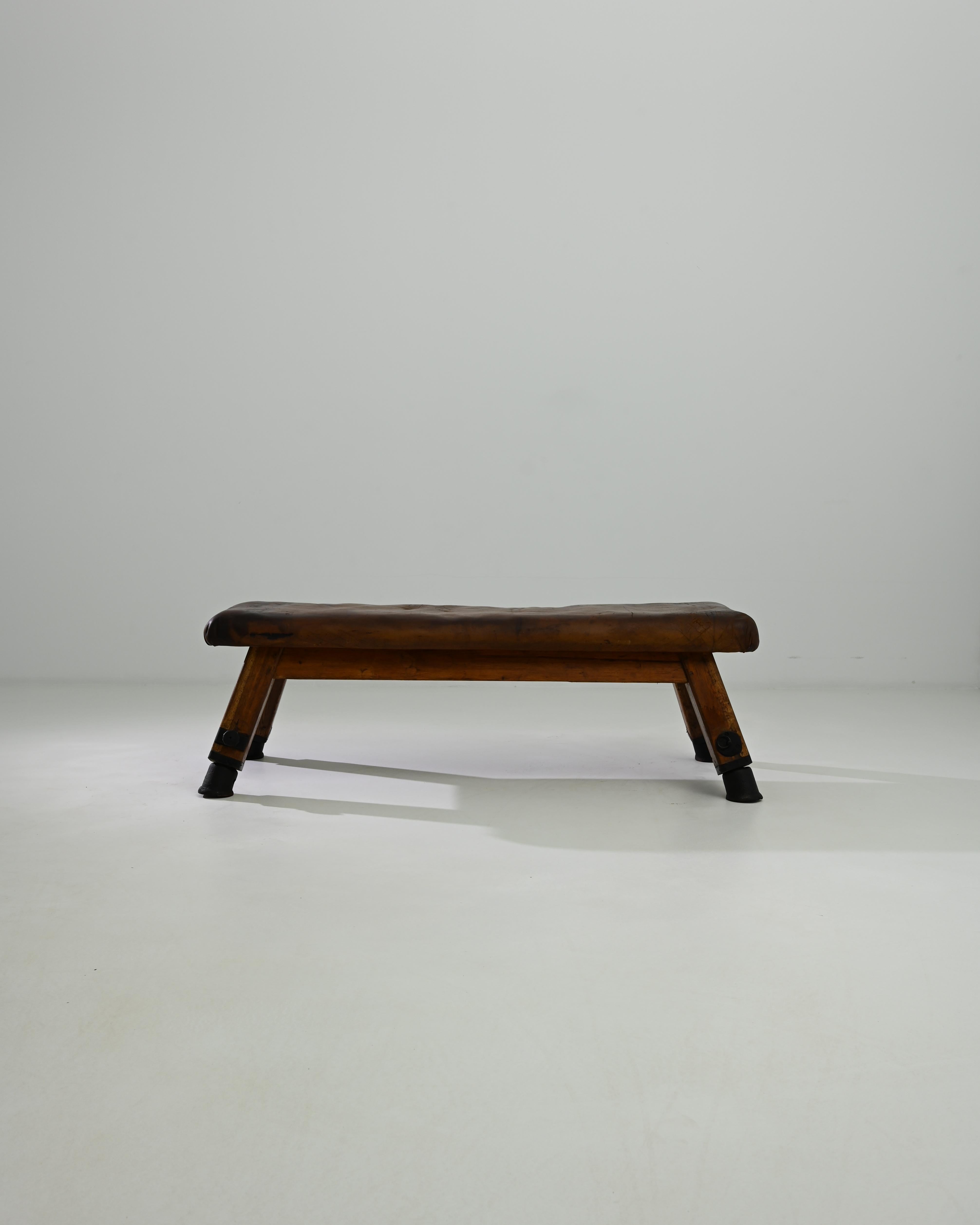 This leather pommel horse was made in Central Europe, circa 1950. A unique bench with a sense of history; hand-crafted quality emits a sense of the robust – utility and a restful sense of ease. Originally used by gymnasts for swinging and balancing
