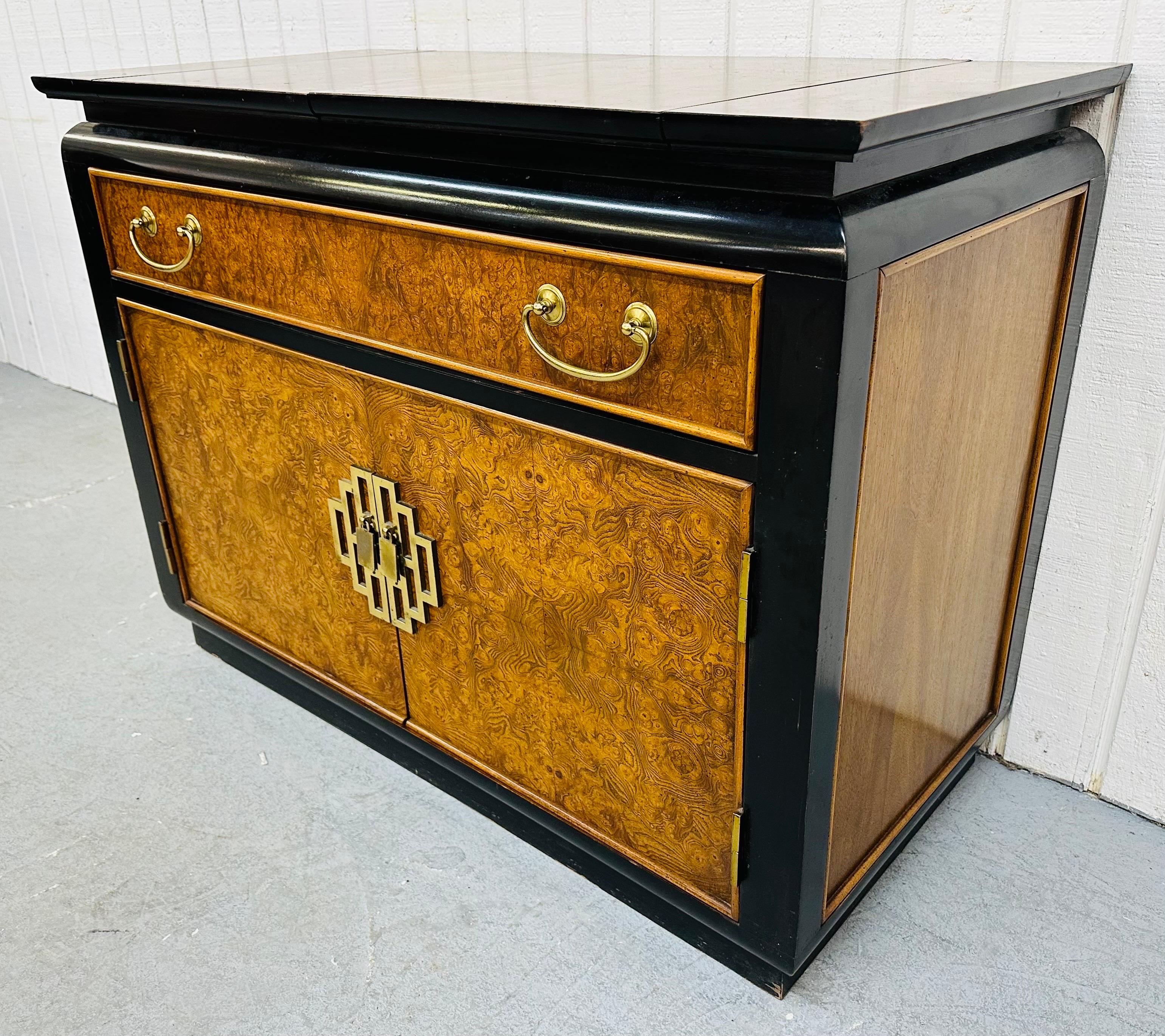 This listing is for a vintage century Burled & Black Lacquered Server. Featuring a fliptop that expands up to 58” L for serving space, one drawer for storage, two doors that open up to storage space, original brass hardware, black lacquered trim,