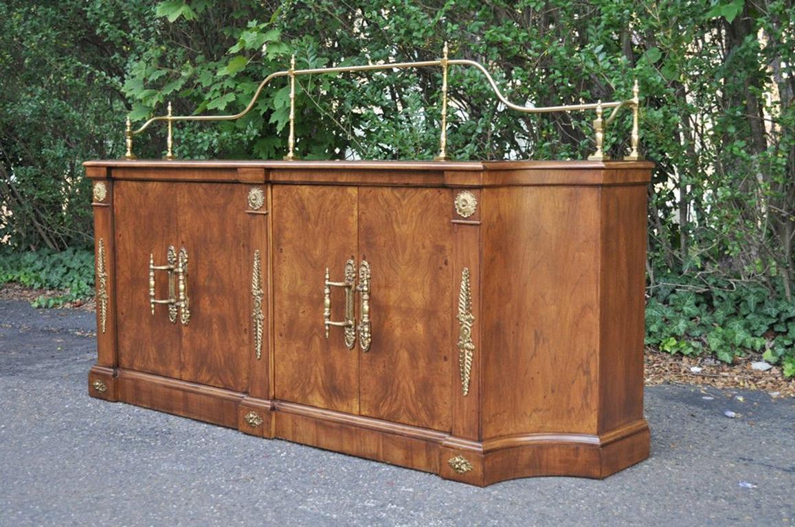 Stunning vintage French Empire / neoclassical style burl wood sideboard/credenza by Century Furniture Company. Item features warm burled woodgrain, brass hardware handles, gallery, ornate feathered ormolu accents. The piece has lower interior