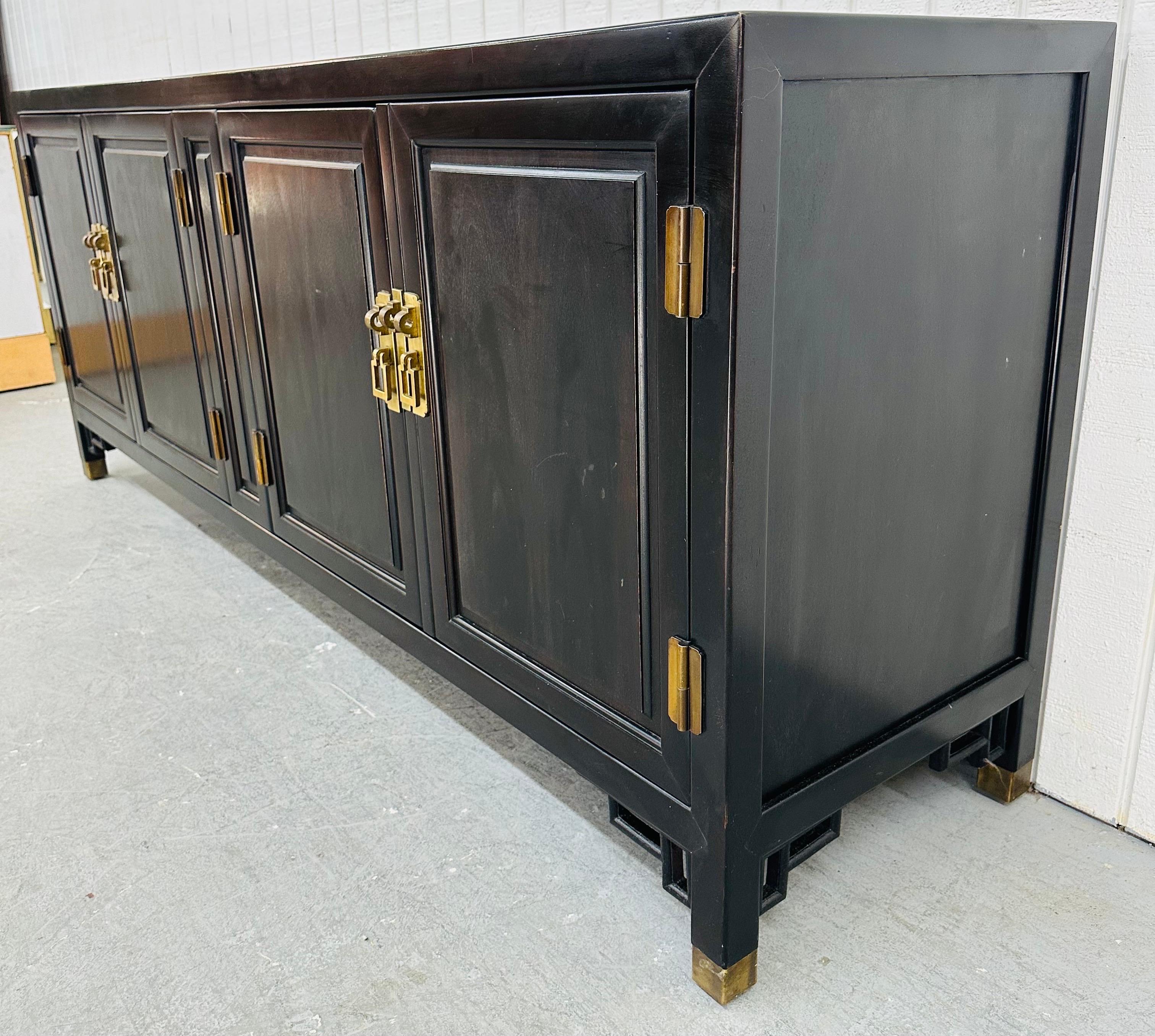This listing is for a Vintage Century Furniture Black Lacquered Sideboard. Featuring a straight line design, two doors on the left side that open up to drawers, two doors on the right side that open up to storage space, modern legs with brass caps,