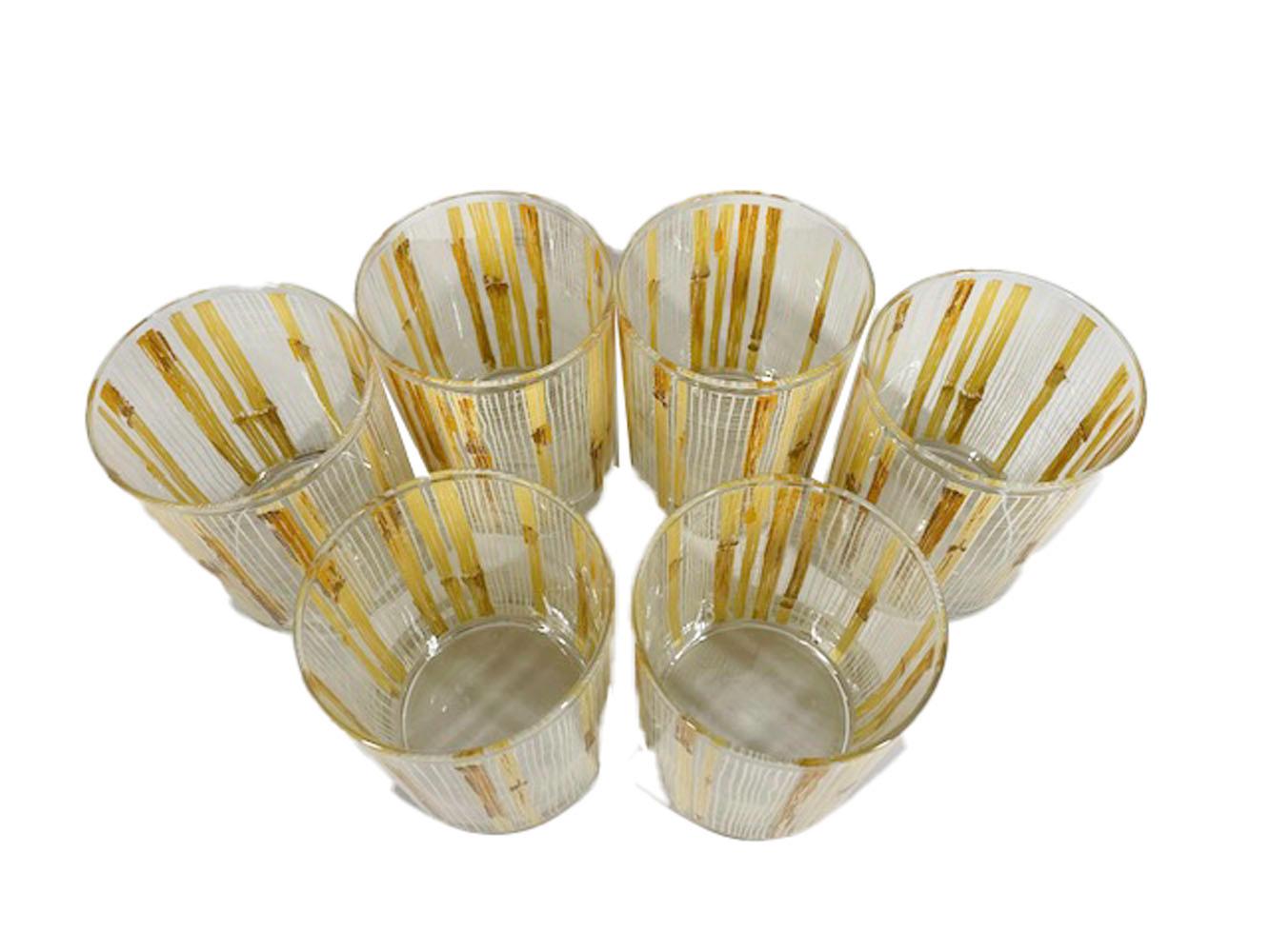 Mid-century rocks glasses made by Cera Glassware and retailed by Neiman-Marcus having a pattern of dried bamboo stocks on a loose-weave mesh ground executed in white, tan and brown enamel.
