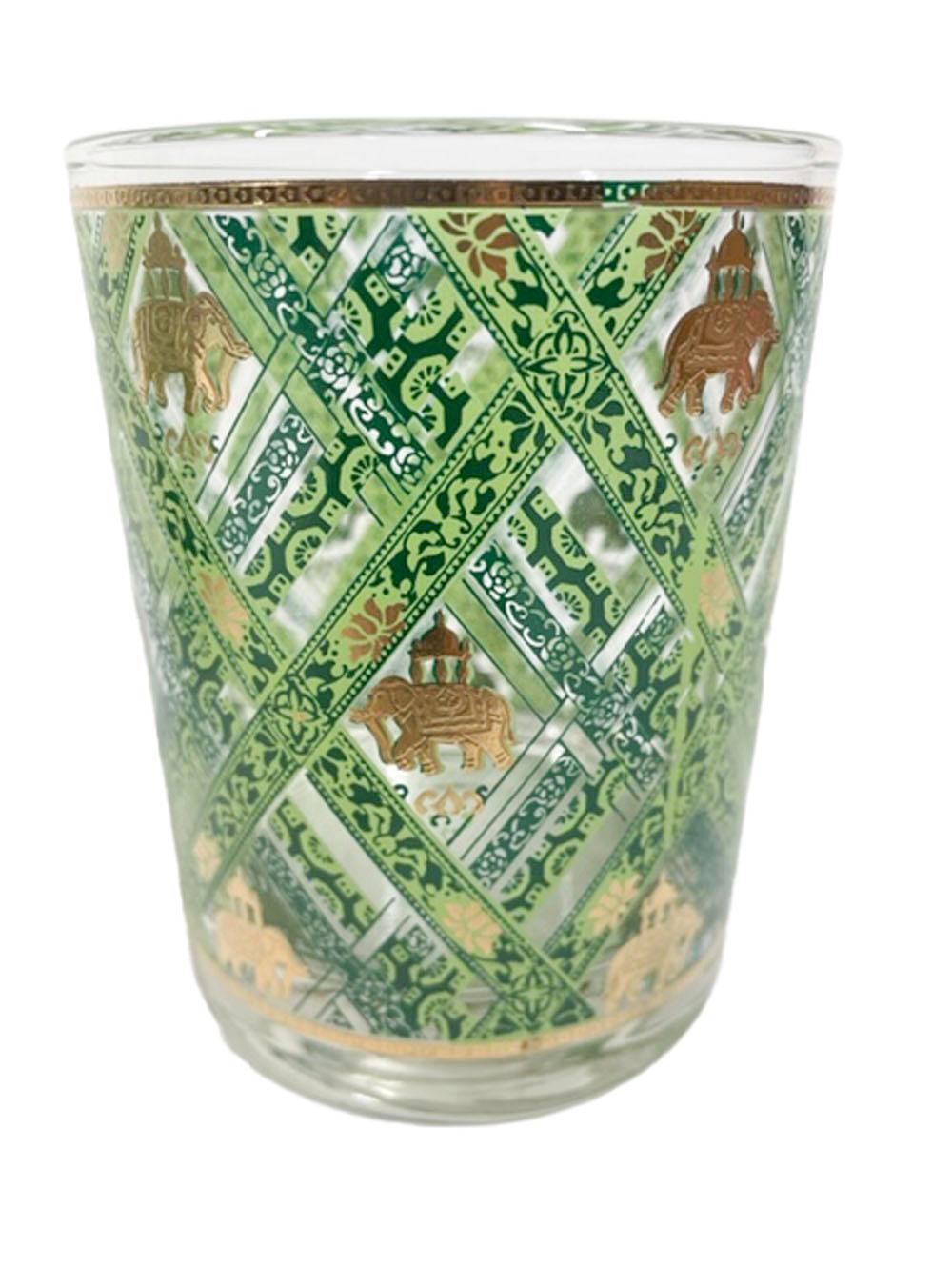 Mid-Century Modern rocks glasses by Cera Glassware decorated with a leafy green-on-green lattice pattern with 22k gold caparisoned Mughal elephants in the openings.