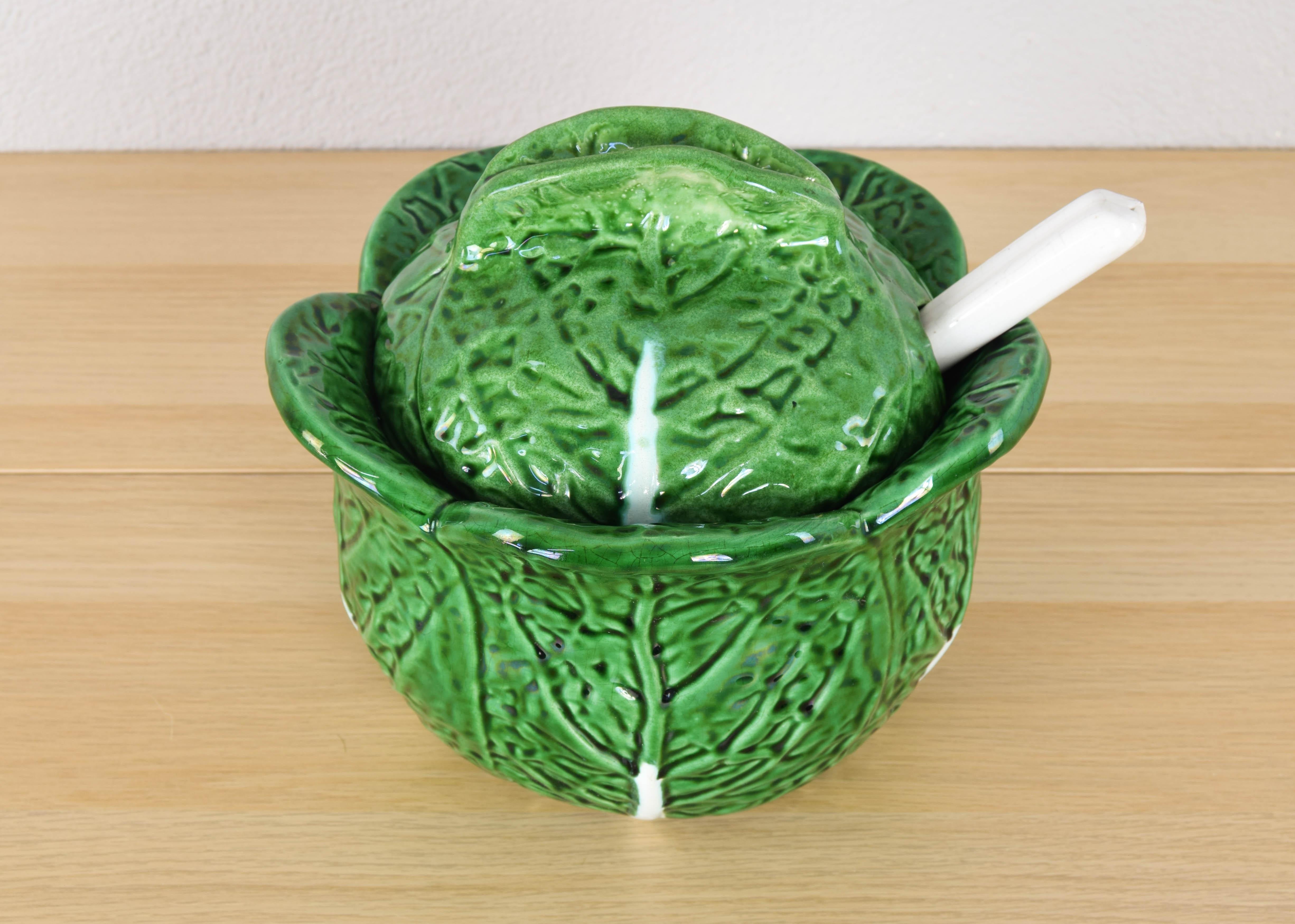 Beautiful and unique enameled ceramic tureen handmade in the shape of a cabbage leaf from Bordallo Pinheiro.
The salad bowl is in excellent condition, with no flaws. Its ladle has a missing tip that is detailed in the image.

These pieces, famous