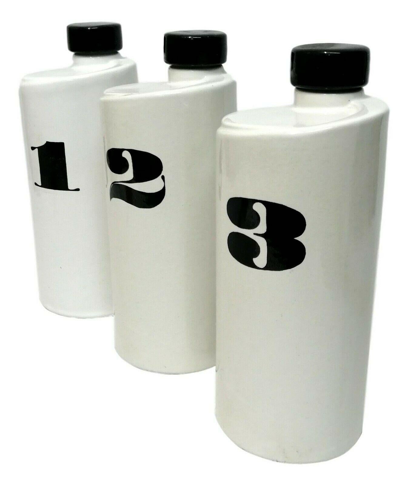 Rare triptych of 70s design ceramic bottles, probably Danish Milan production or Ceramiche pozzi (traces of the label under a bottle), with numbers 1,2,3 in black enamel on an absolute white background

They measure 25 cm in height by 10 cm in