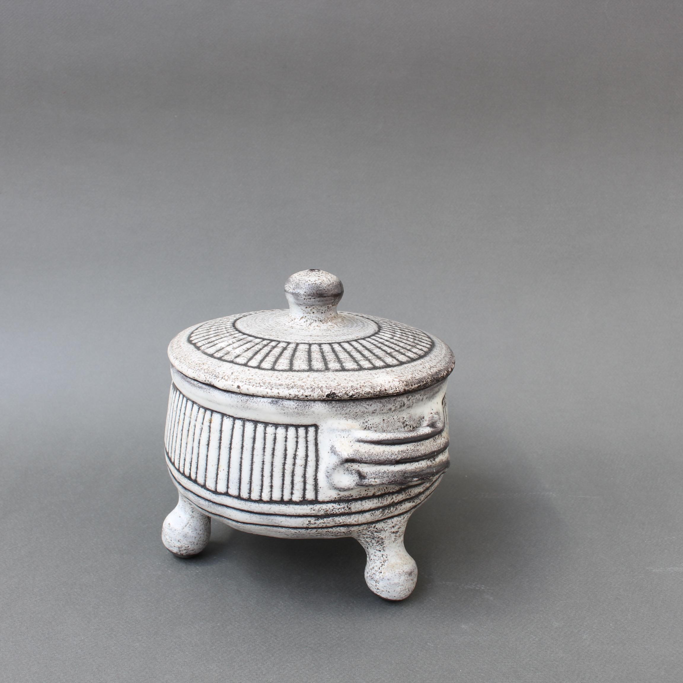 Mid-century ceramic bowl with tripod legs by Jacques Pouchain / Atelier Dieulefit. Pouchain's signature cloudy glaze style is evident but in this piece, which takes the form of a compressed barrel-shaped, there is a vertical line motif throughout.