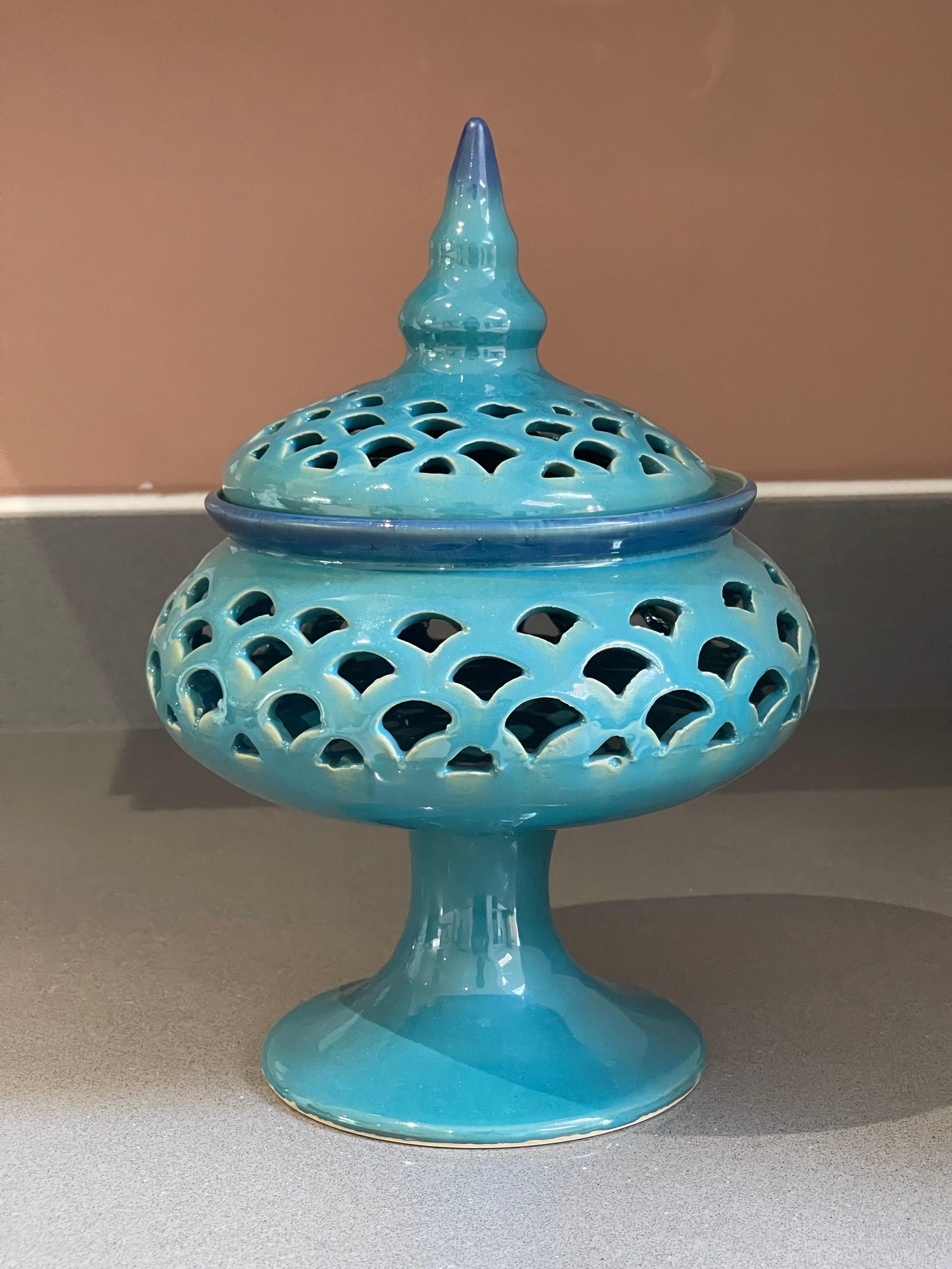 Turquoise blue Blue Ceramic Torches With Stand &Lid, Vintage Ceramic Candle Holder Hand Crafted, pressed, cast, and chased. Circular, curved feet stand.
Highly collectable and valuable.
Measures: H x W x D: 25 x 15 x 14 cm.


It is in beautifully