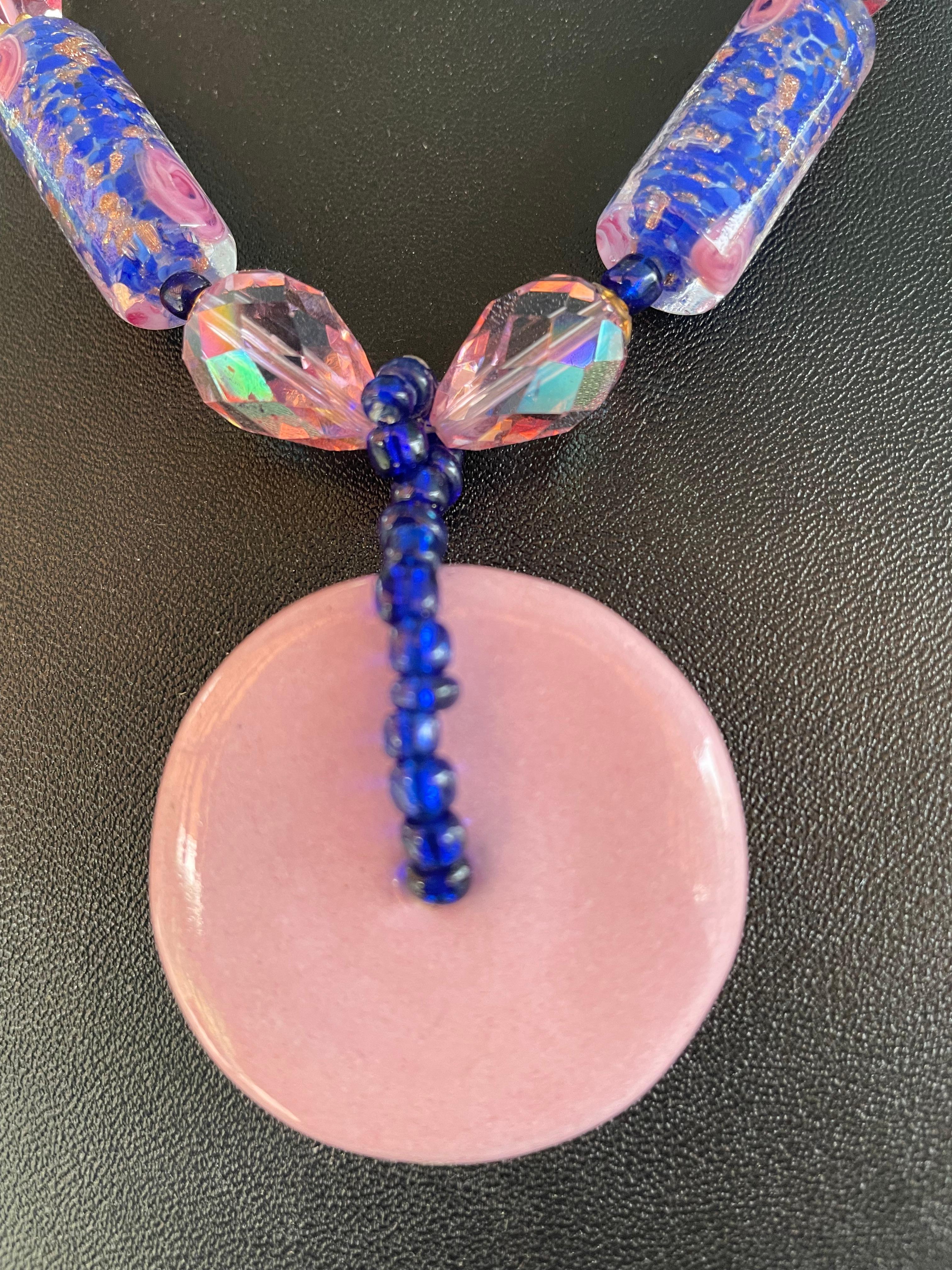 Vintage glazed pink Ceramic Disc, Vintage blue and pink cased glass Venetian beads,rose quartz, and gold crystal bicone beads comprise this lovely necklace.These Venetian beads are from the island of Murano and are a gorgeous example of the cased