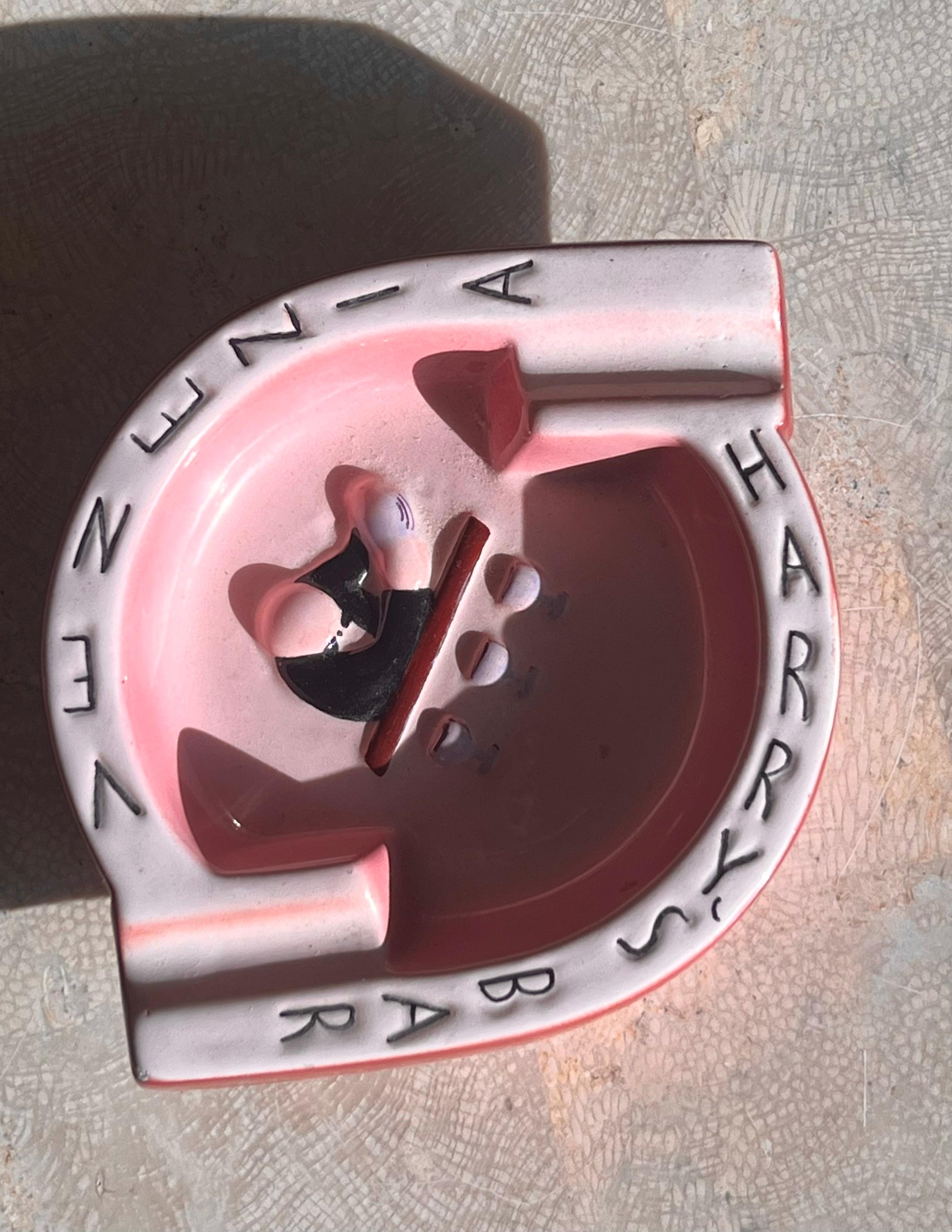 A collectible pink ceramic ashtray from Harry’s Bar in Venice, Italy mid 20th century. Tones of bubblegum, mauve, burgundy, and licorice. Marked “Harry’s Bar Venezia” and “Made Italy” on verso. Opening its doors in 1931 by Giuseppe Cipriani Senior,