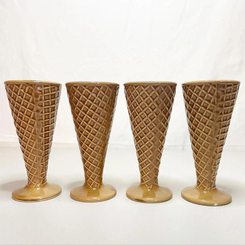 Exceptional set of 4 ceramic sculpted ice cream cones. Each one looks good enough to eat with a sticker underneath.