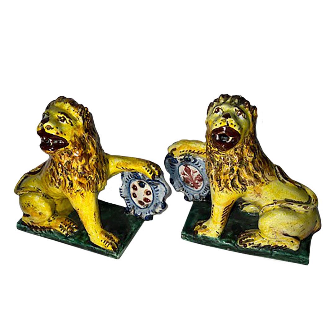 A pair of ceramic lions with Italian insignias. Circa 1990s, Italy.