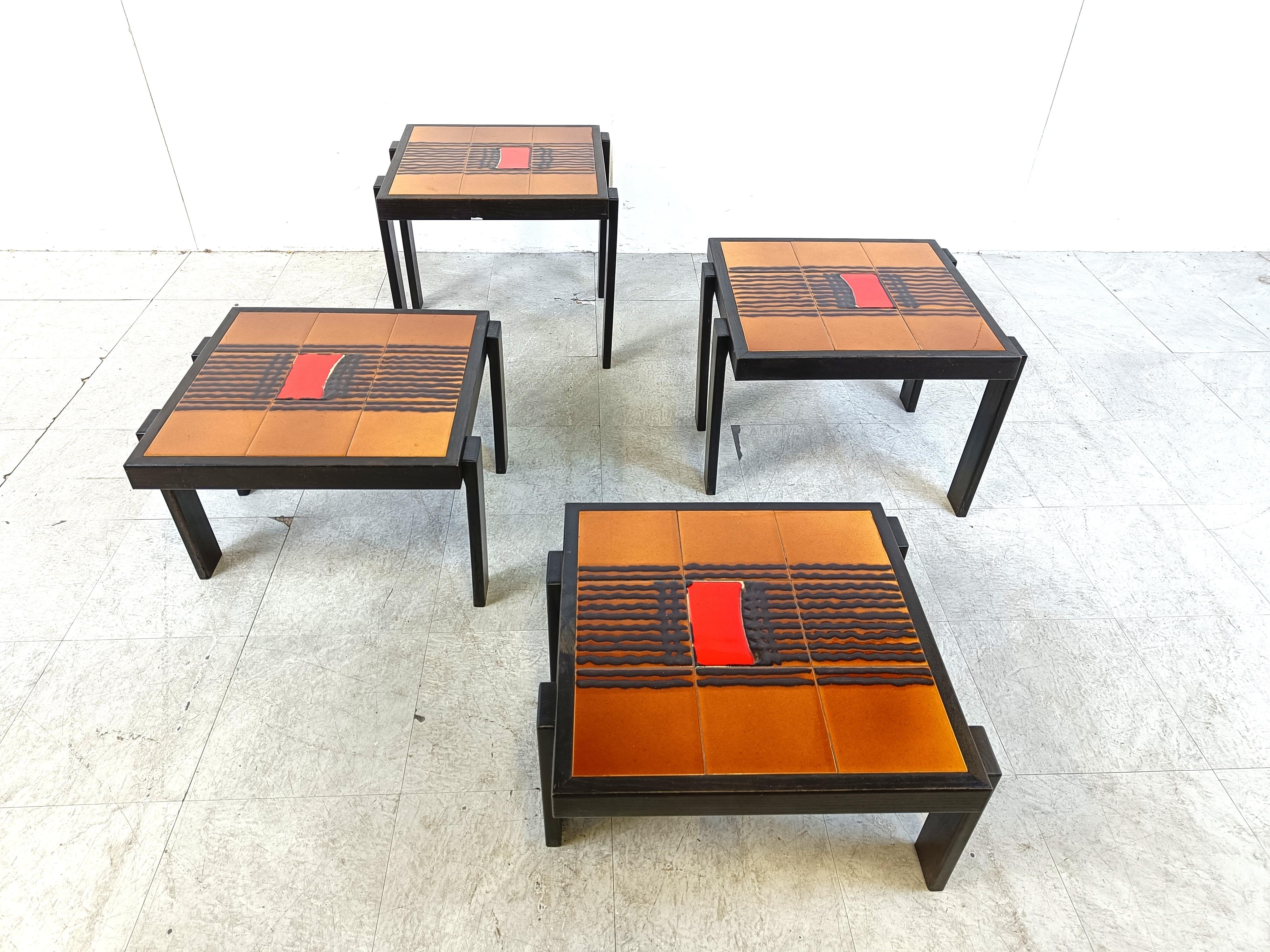 Set of 4 ceramic nesting tables with brown wooden frames.

Beautiful and very typical sixties ceramic tiling.

Great to contrast a very modern living room.

1960s - Belgium

Good condition

Dimensions:
Largest table: 
Height: 46cm
Width: 55cm
Depth: