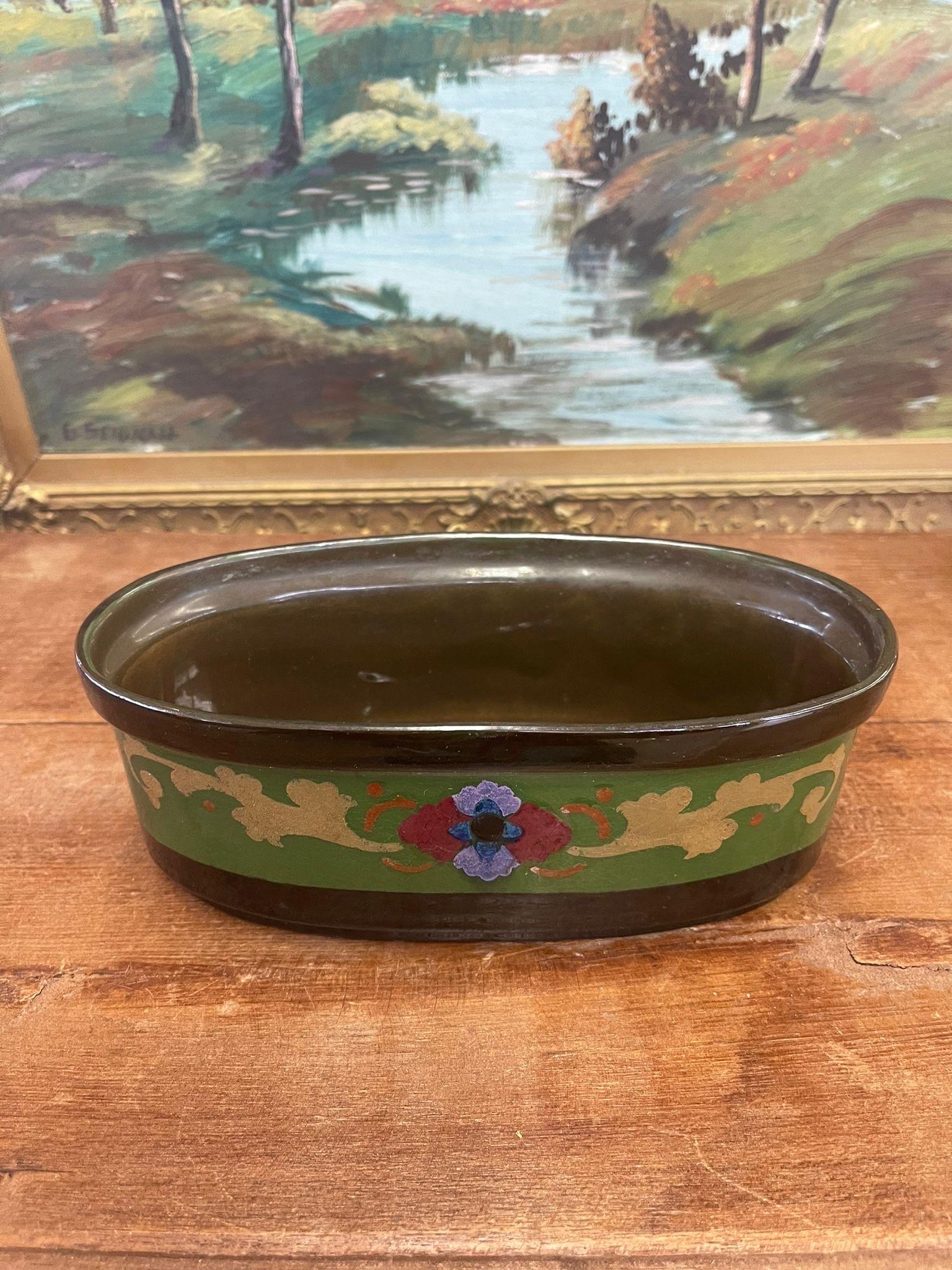 Traditional floral design atop this unique ceramic piece.Makers mark on the bottom stating that was made in Holland. Made in the Early 1900s. Hand Painted. Vintage Condition Consistent with Age as Pictured.

Dimensions. 9 W ; 4 1/2 D ; 3 H