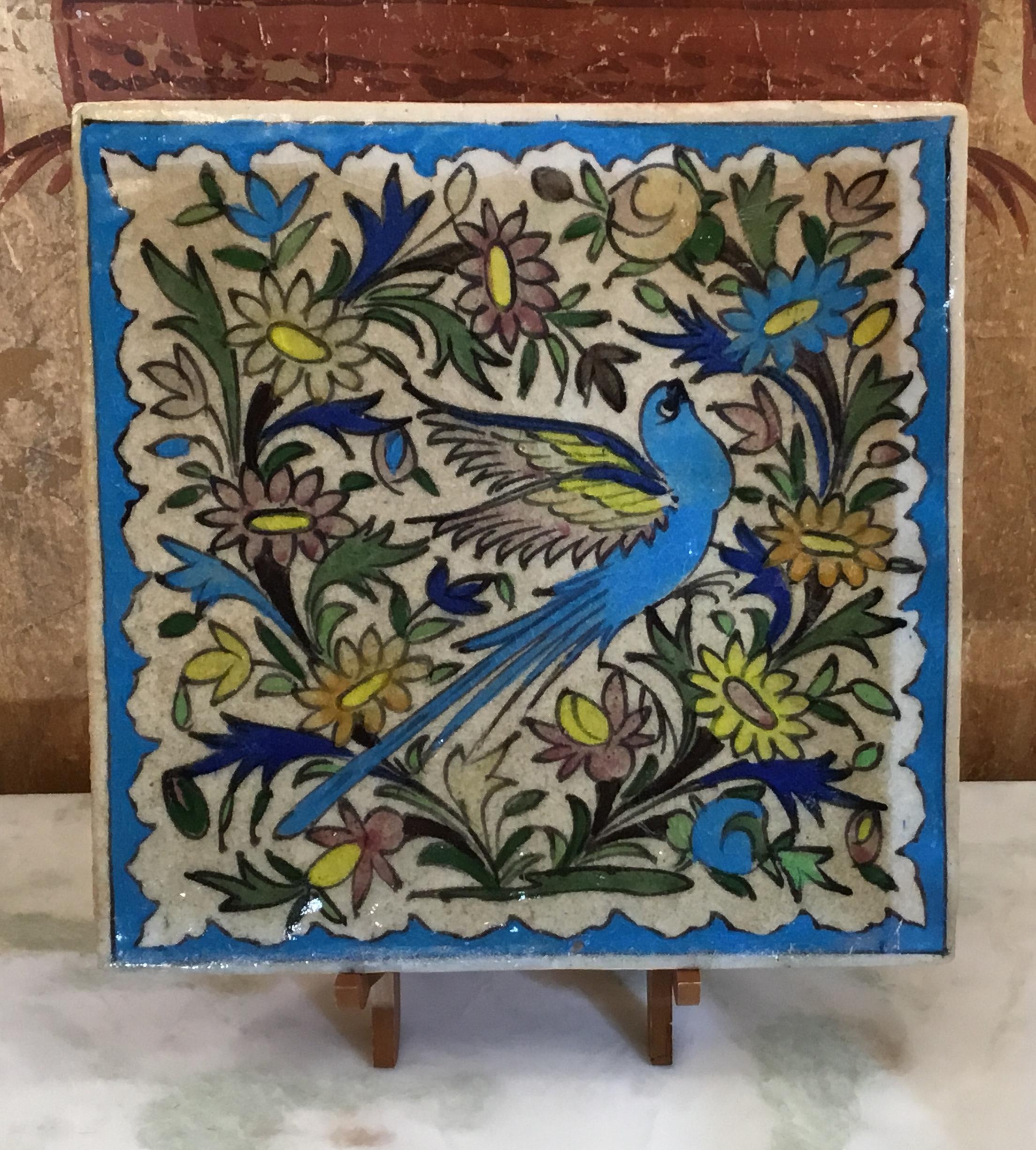 Beautiful Persian tile hand painted and glazed with exceptional painting of bird surrounds in colorful flowers and vines scenery.
The tile can hang on the wall, or display on a wood stand. Wood stand included.
 