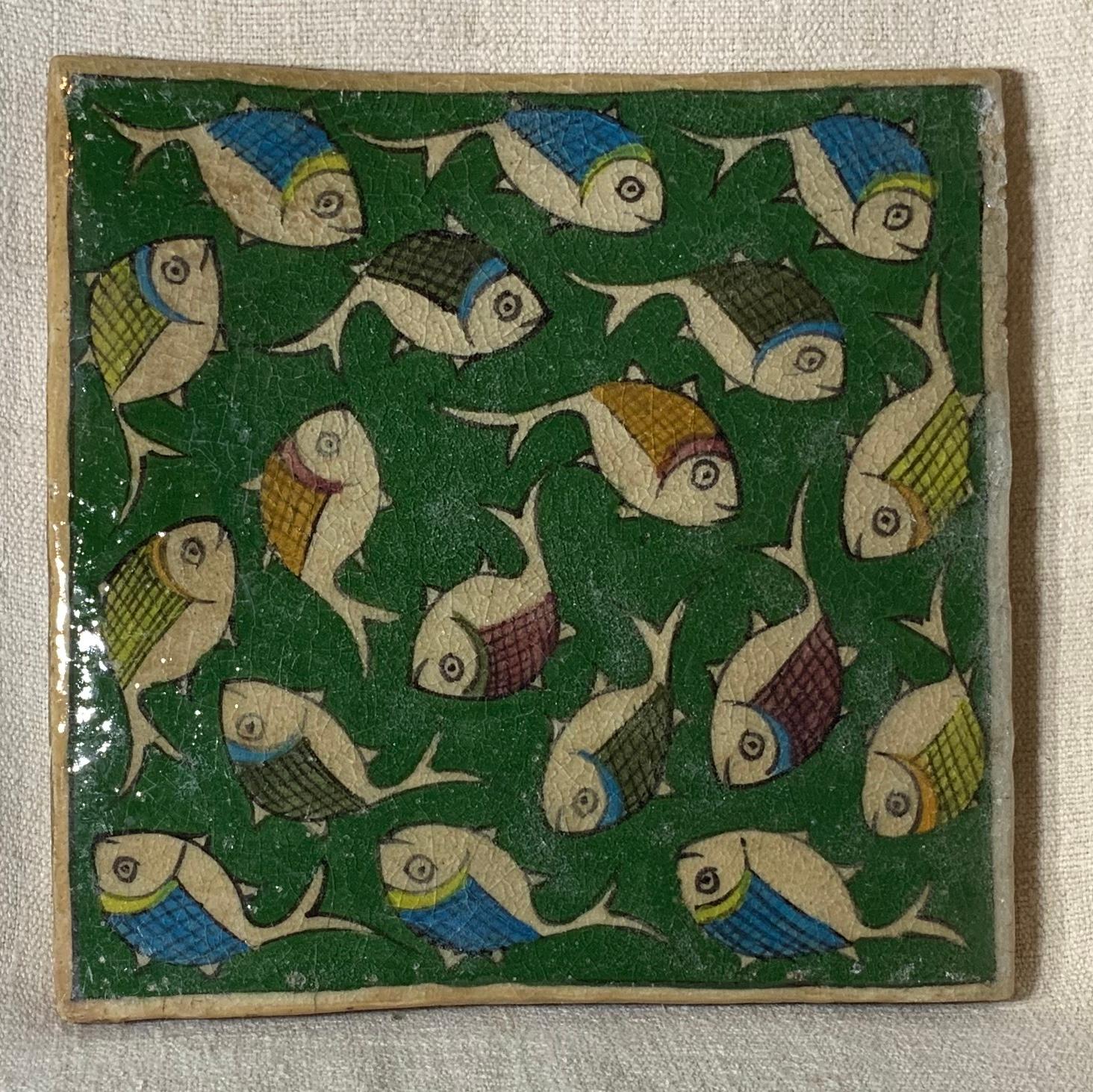 Beautiful Persian tile hand painted and glazed with exceptional wondering school of colorful fish, on a green color background.
The tile can hang on the wall, or display on wood Stand, wood Stand is not included.